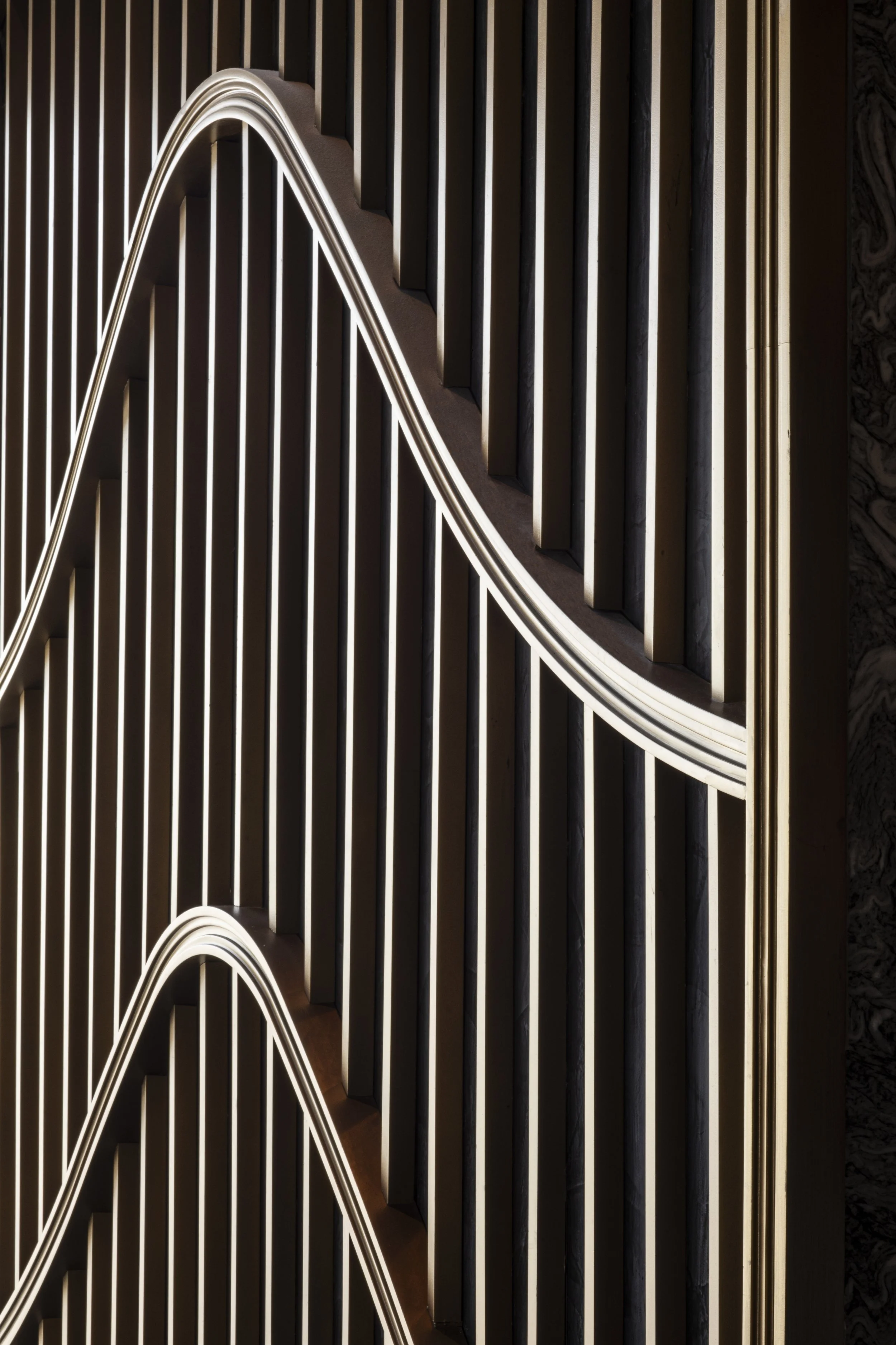 A close up detail o the column slats in gold finish.