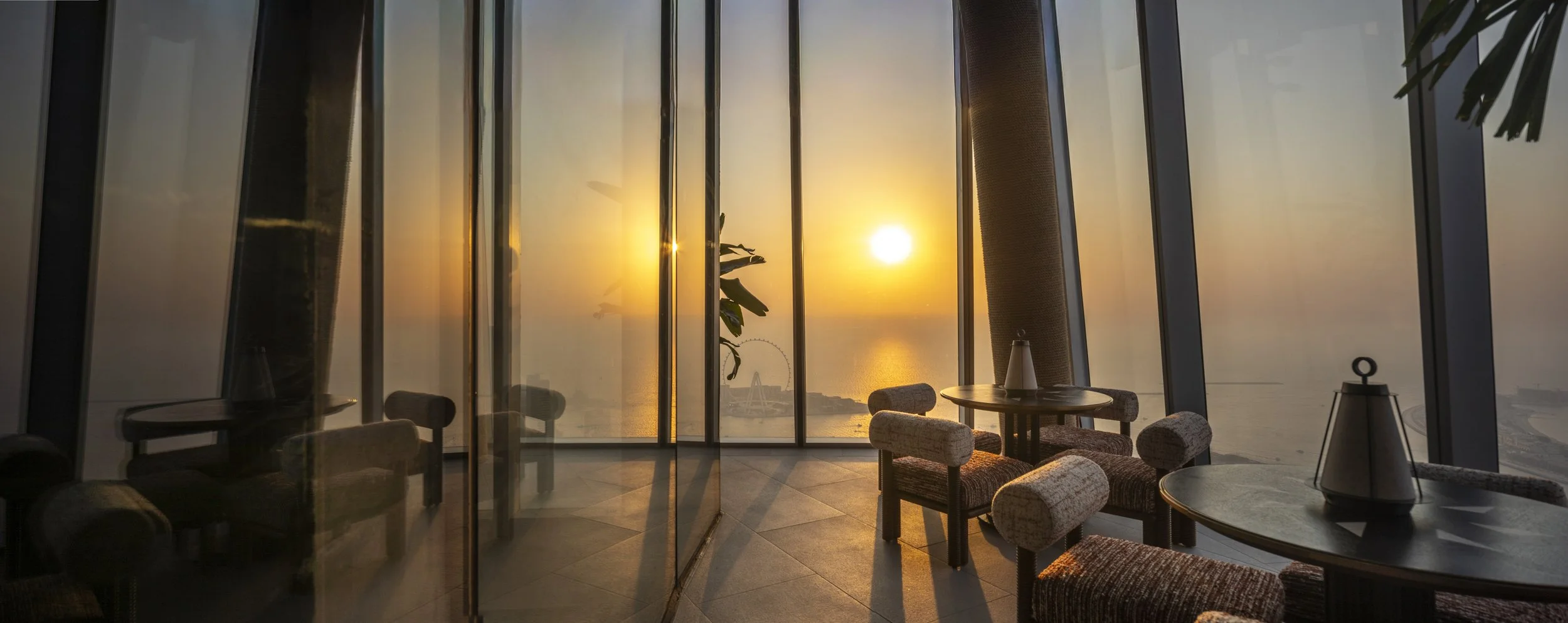 A view of the 360 degree viewing deck on level 81 of the ciel tower in Dubai at sunset.