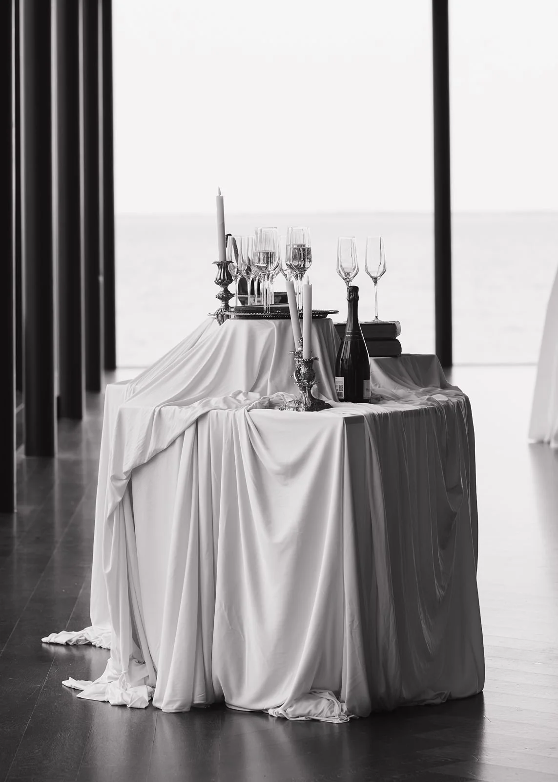 Black and white photo of a champagne table inside The Warm Mamorial.
