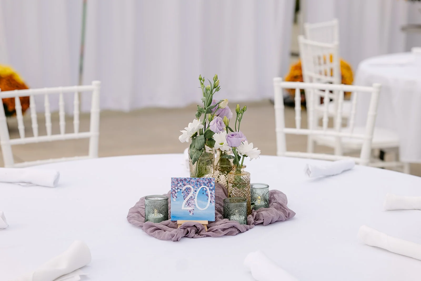 Colorful hand-painted table numbers for an Abele Greenhouse wedding reception in Saginaw, Michigan.