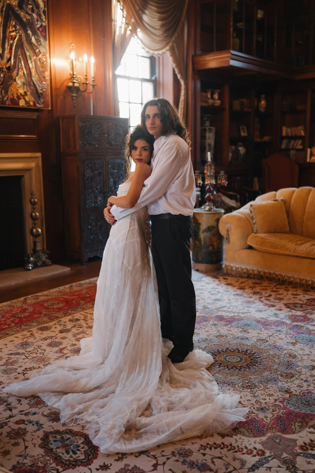 A traditional portrait of a bride and groom inside the lavish, renaissance inspired Clairwood Estate wedding venue in Michigan.