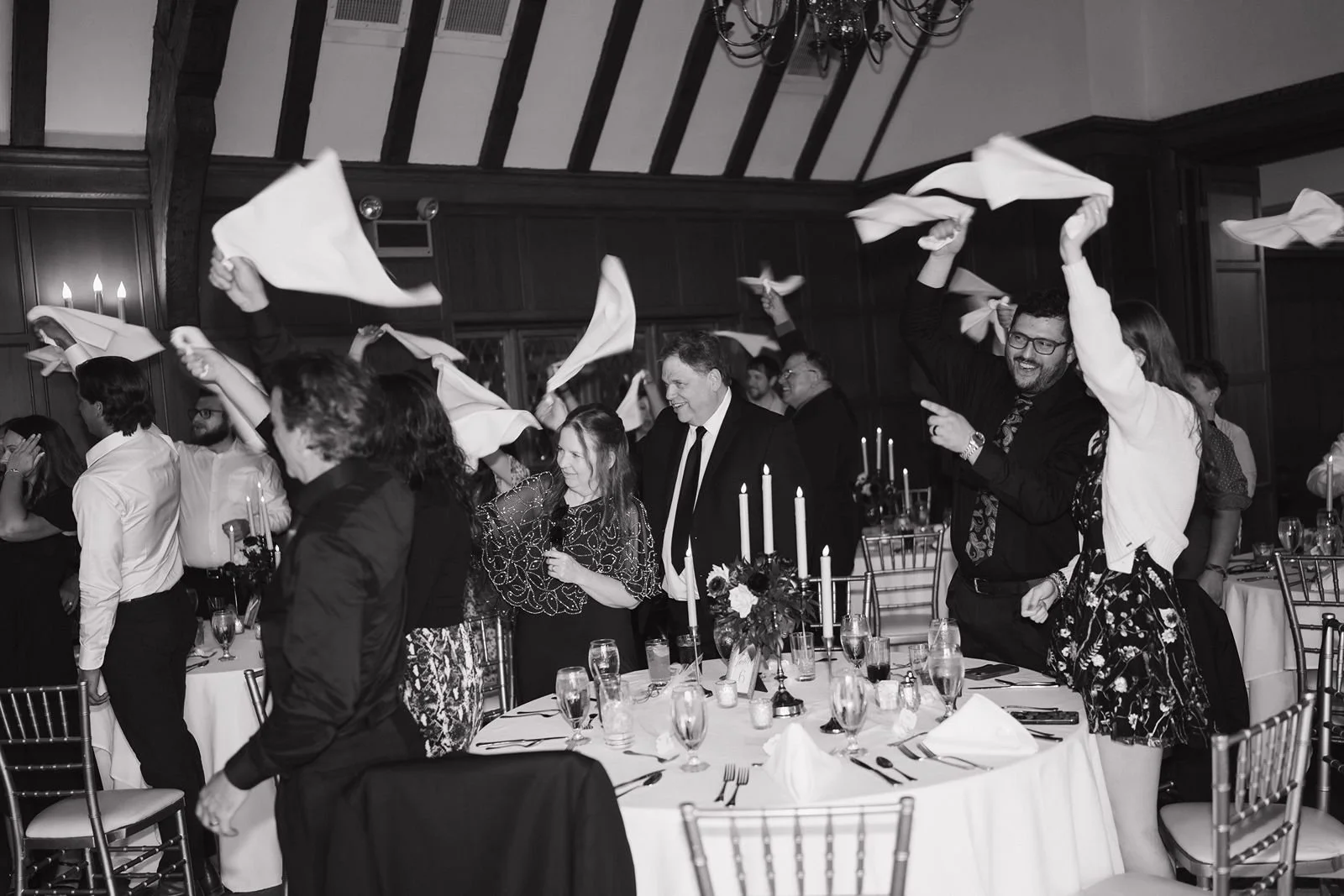Wedding guests twirling their napkins for the wedding couples grand entrance to the reception.