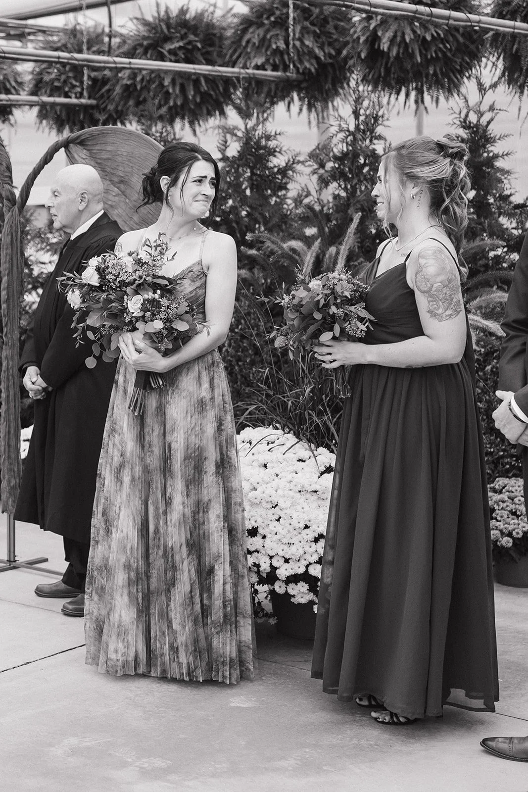 Black and white photo of the bridesmaids getting emotional during the ceremony.