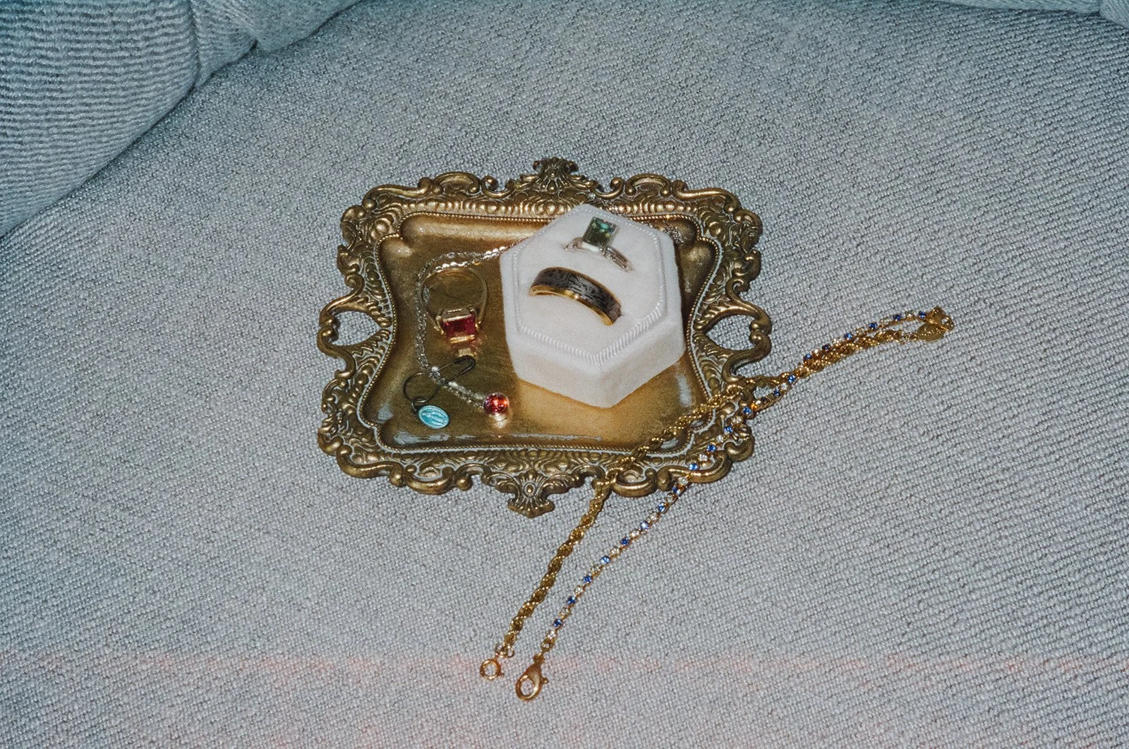 Film photo of jewlery, wedding band, wedding rings, and other heirloom pieces.