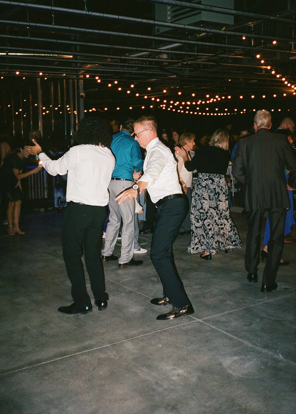 Film photo of guests dancing.