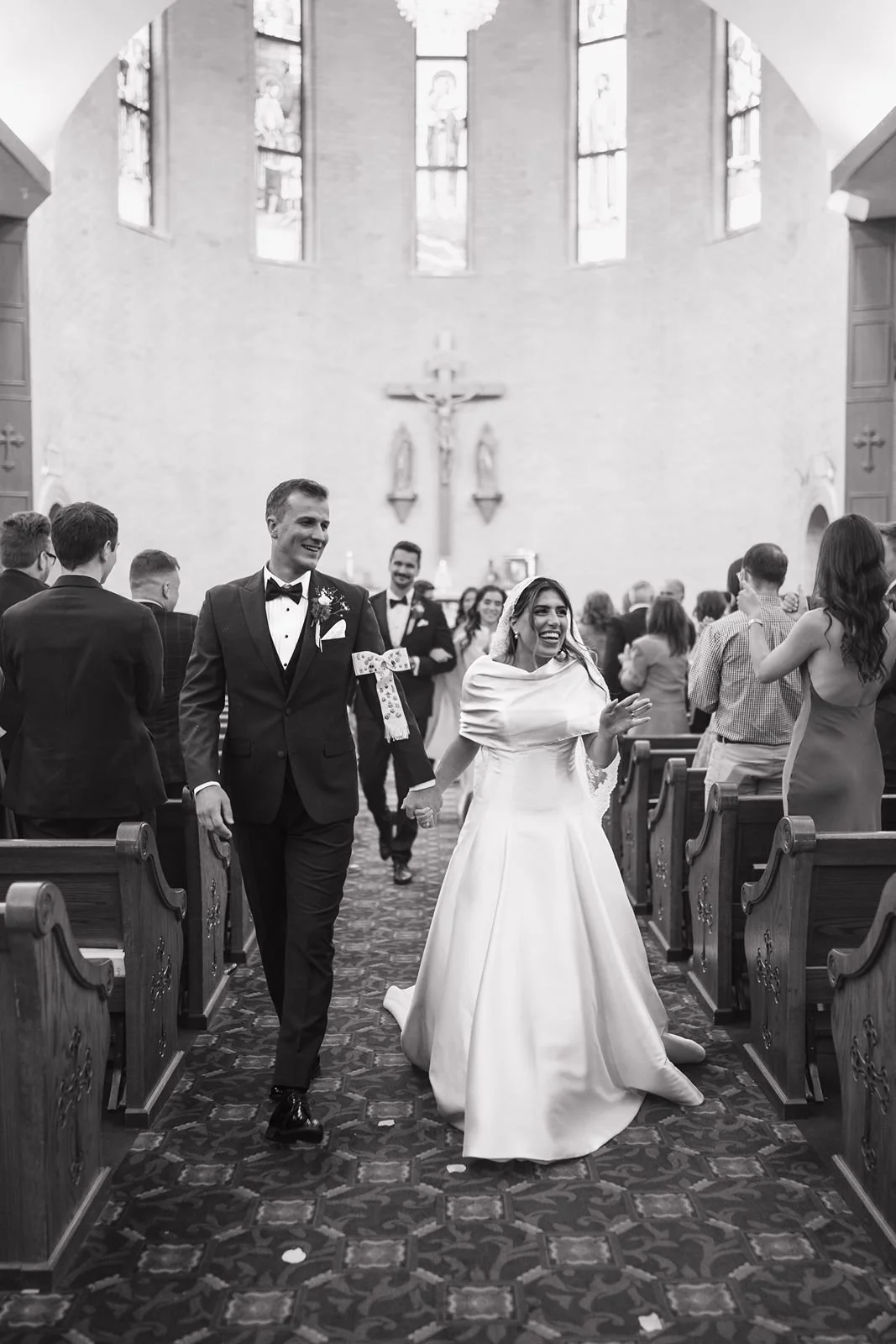 A bride and groom exiting their ceremony after being wed at Mother of God Church in Michigan.
