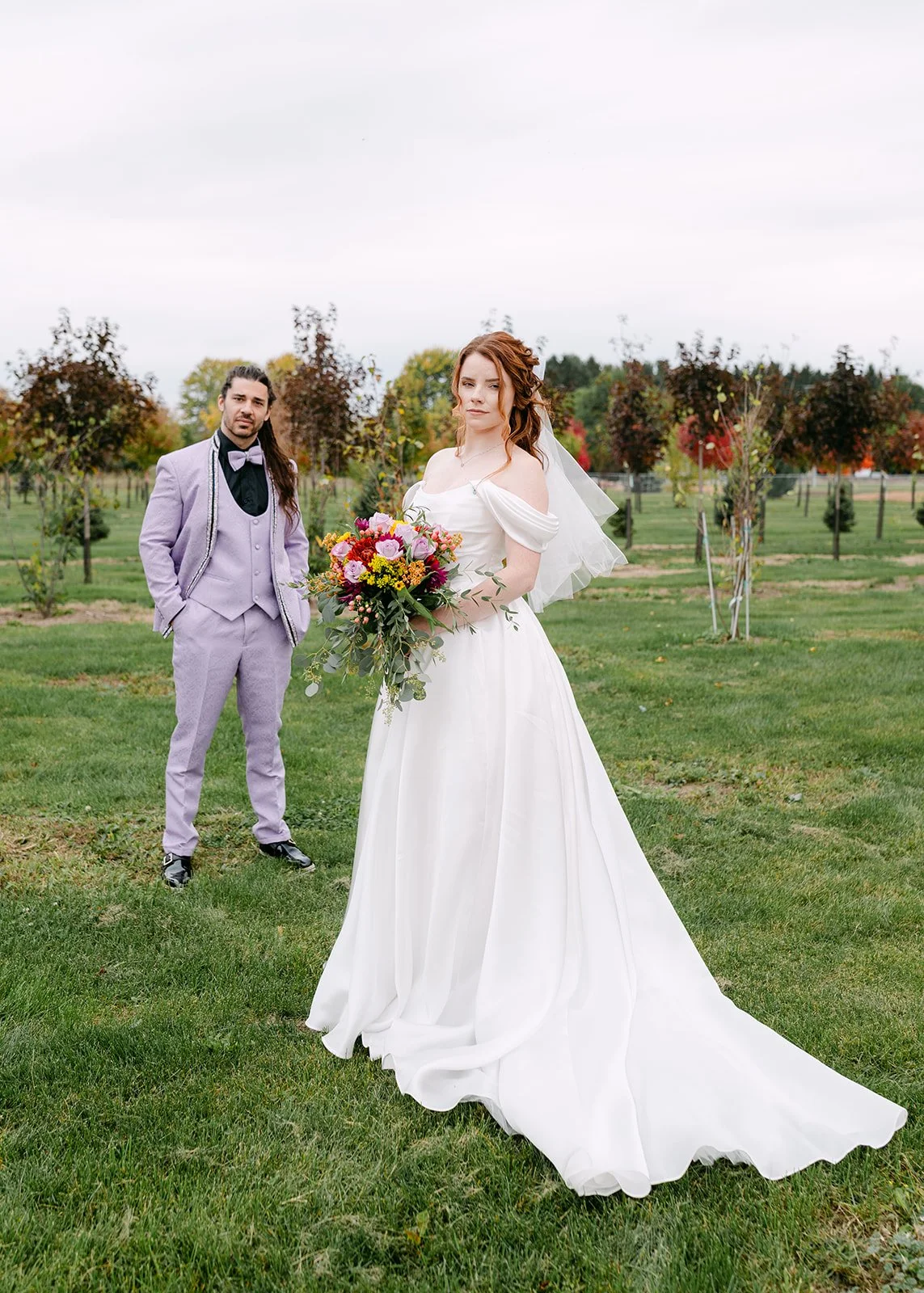 Bride and groom posing on the property at Abele Greenhouse in Saginaw, Michigan.