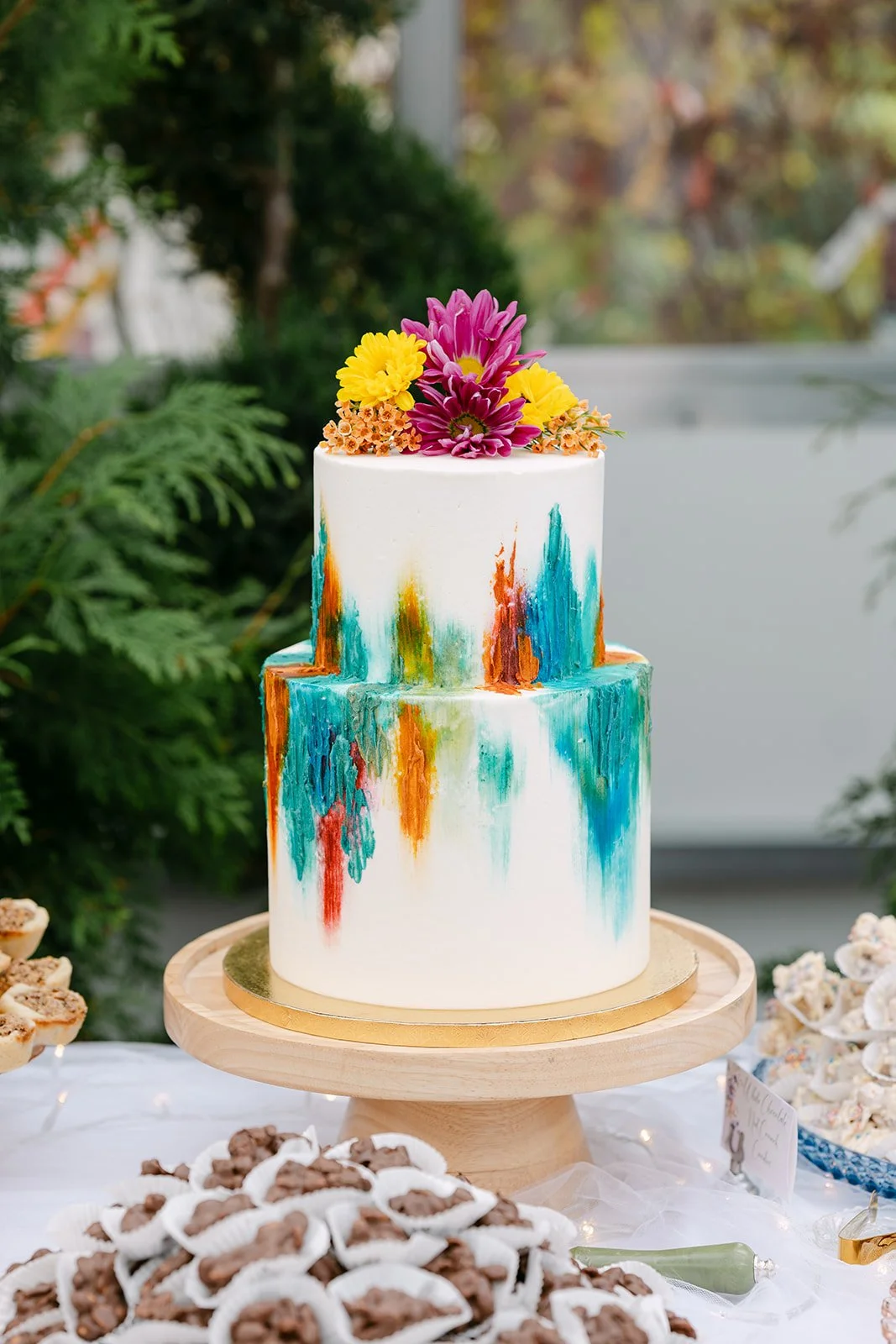 Colorful wedding cake at Abele Greenhouse wedding reception in Saginaw, Michigan.