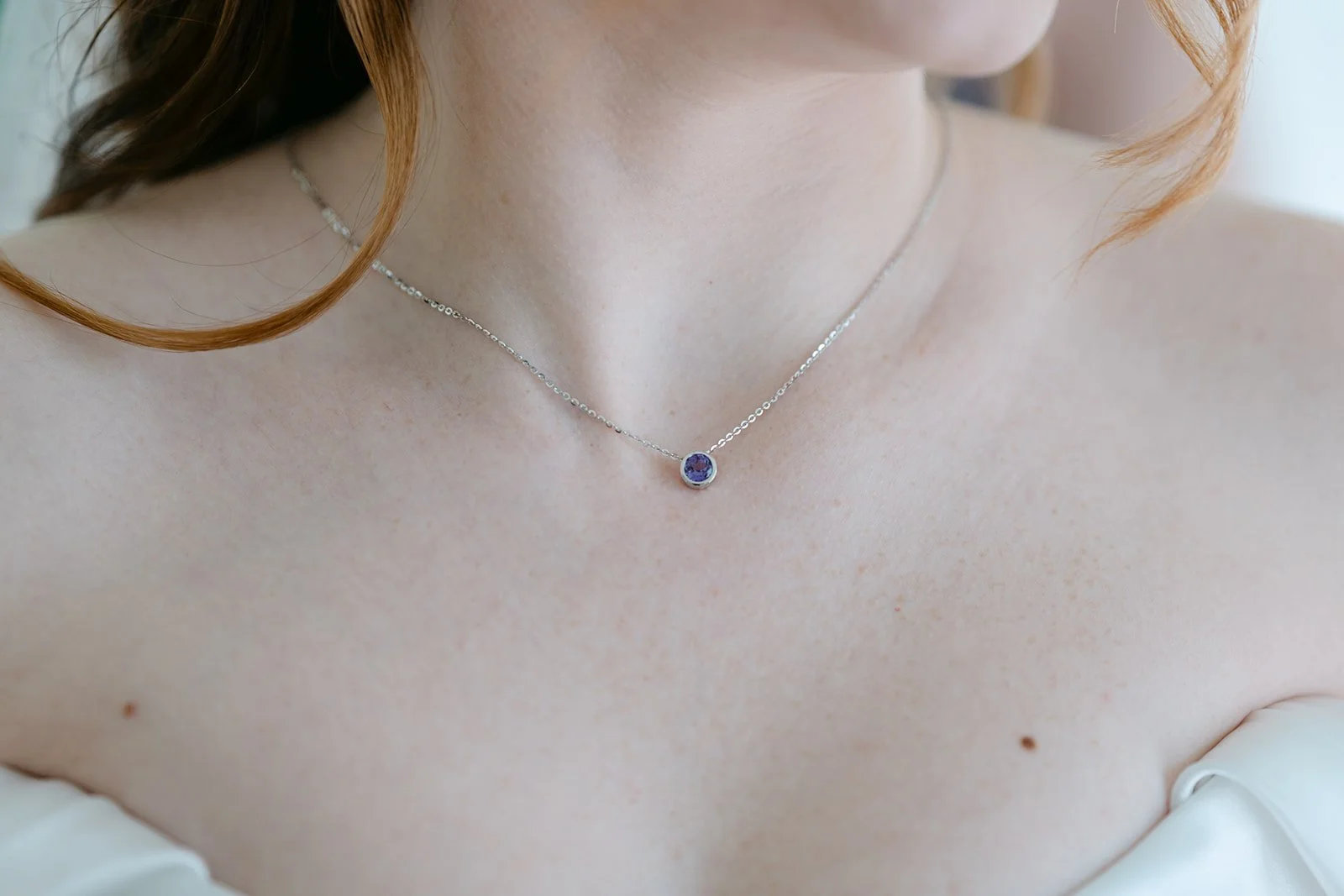 Bride wearing a necklace gifted to her by her father.
