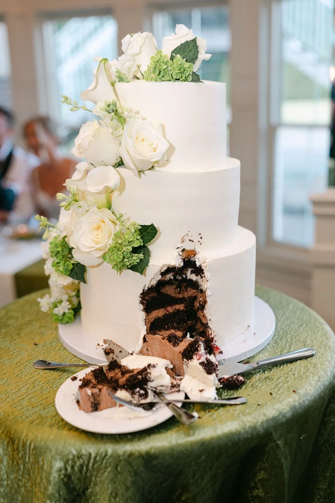 A wedding cake with a slice cut out.