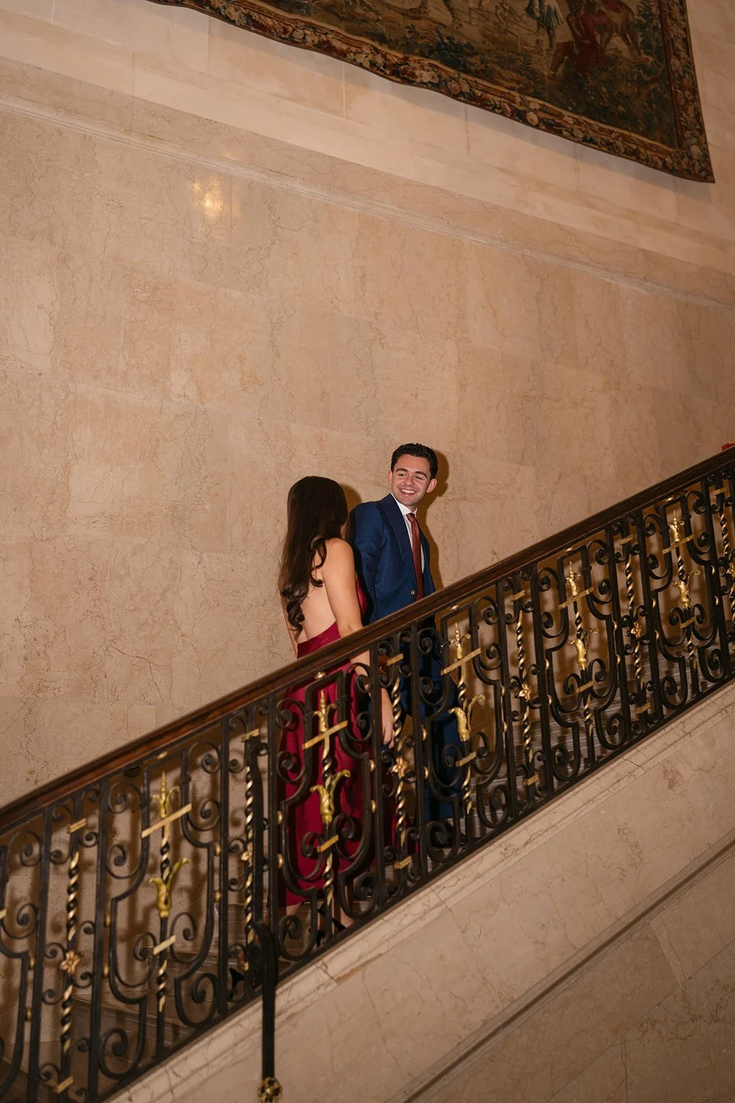 Couple walking up the staircase together at Detroit Athletic Club.