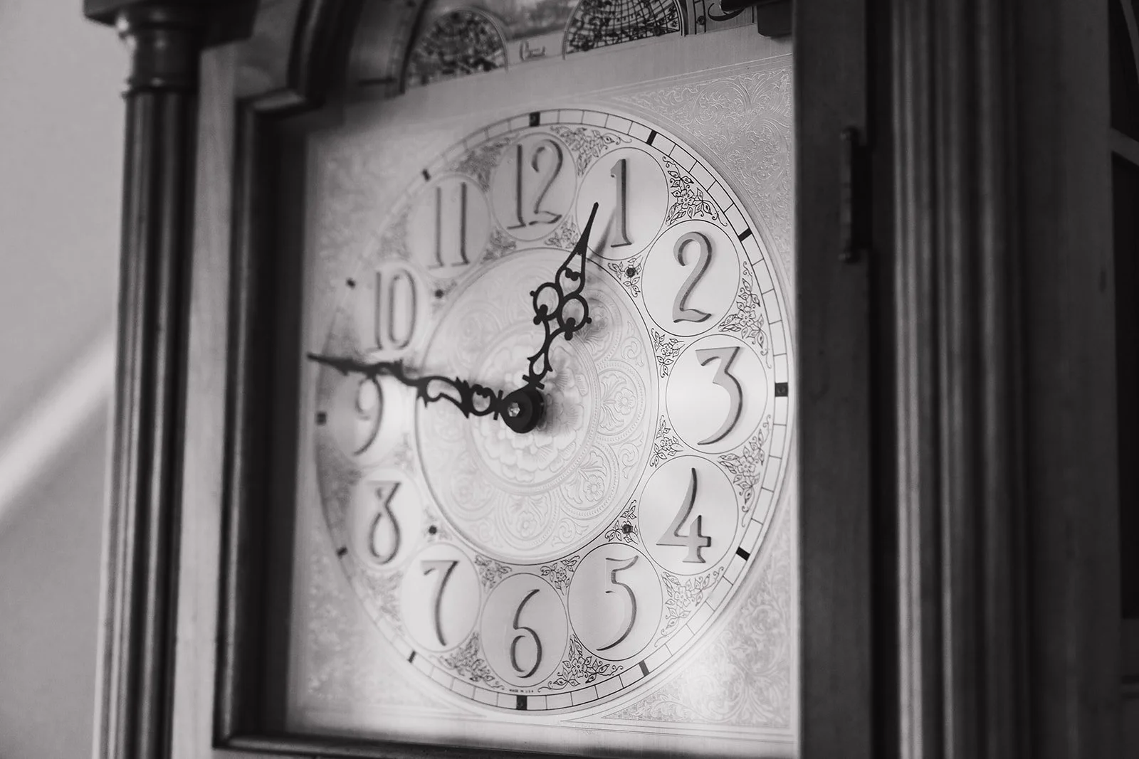 Black and white photo of a vintage hand clock.