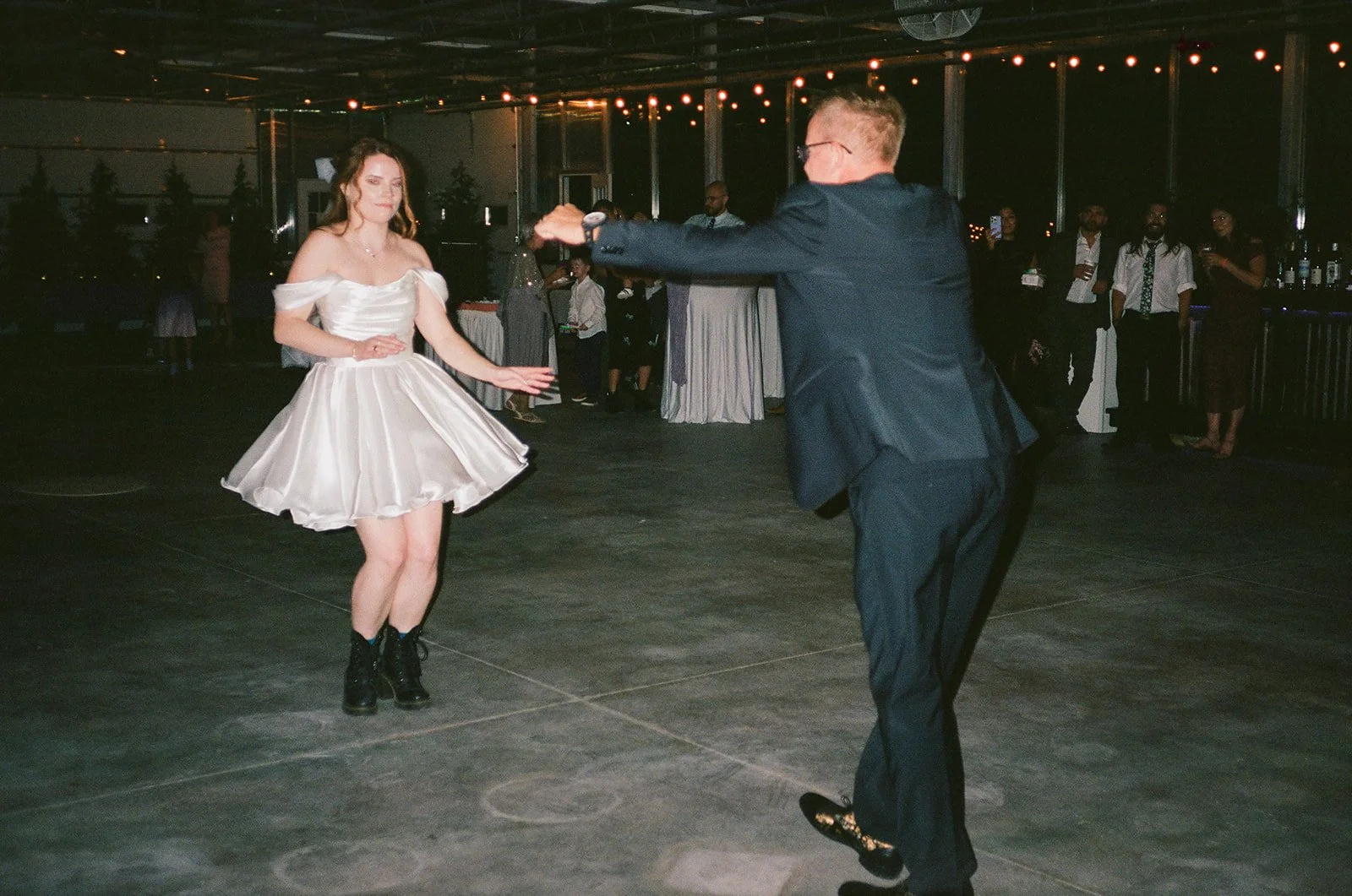 Film photo of the bride dancing with her father.