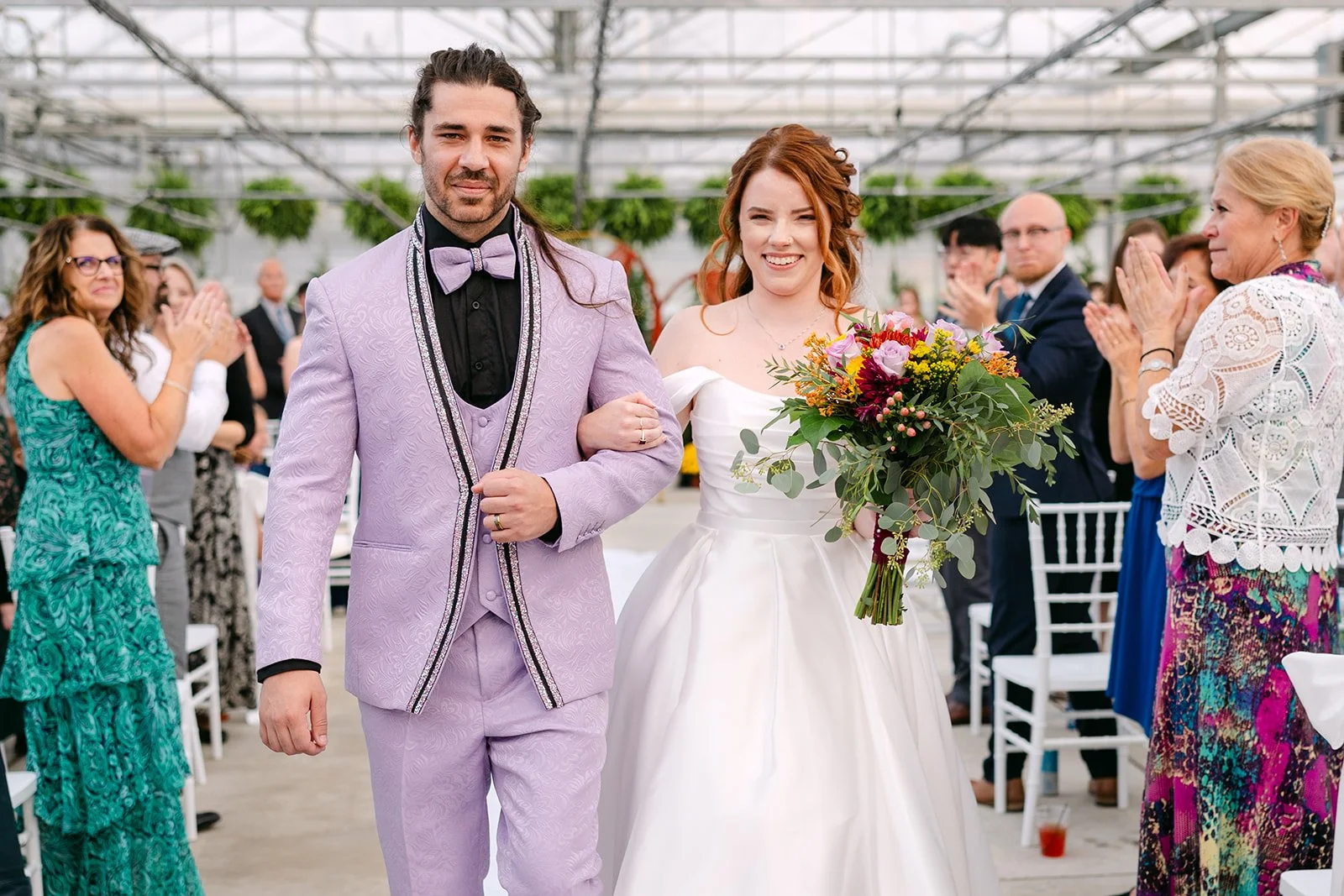 Bride and groom walking back down the aisle for their Abele Greenhouse wedding ceremony.