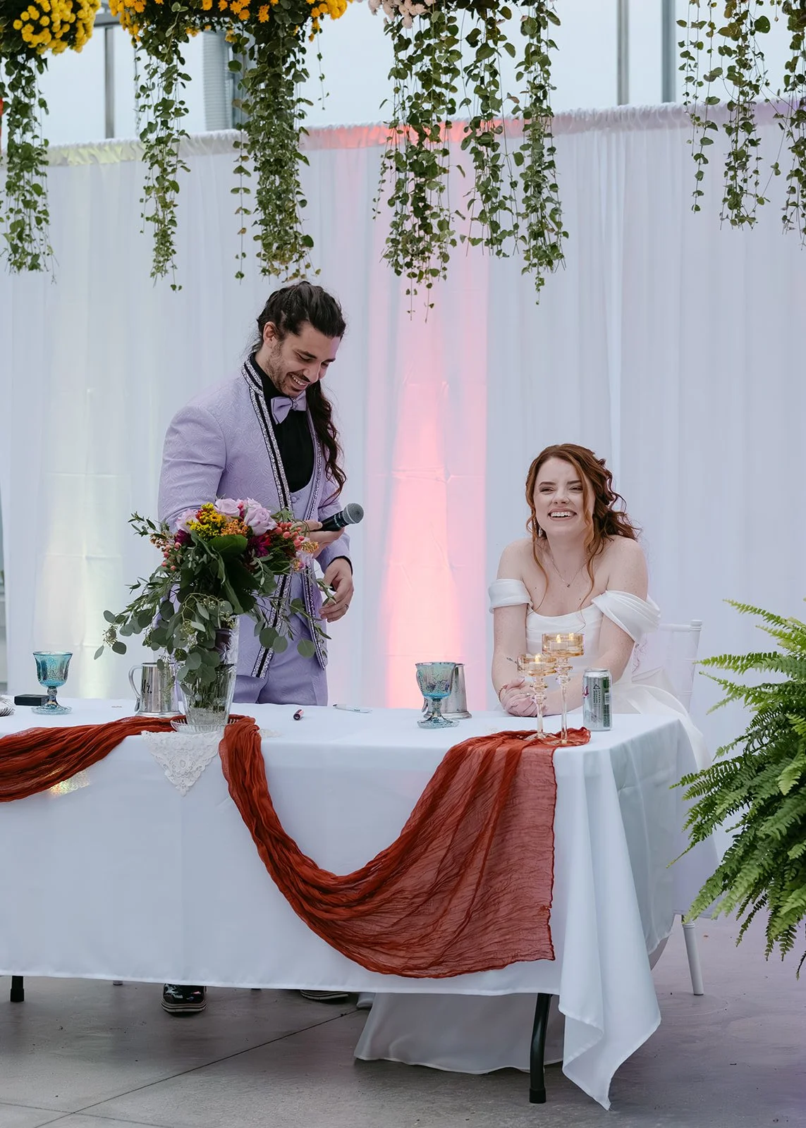 Bride and groom giving speeches during Abele Greenhouse wedding reception in Saginaw, Michigan.