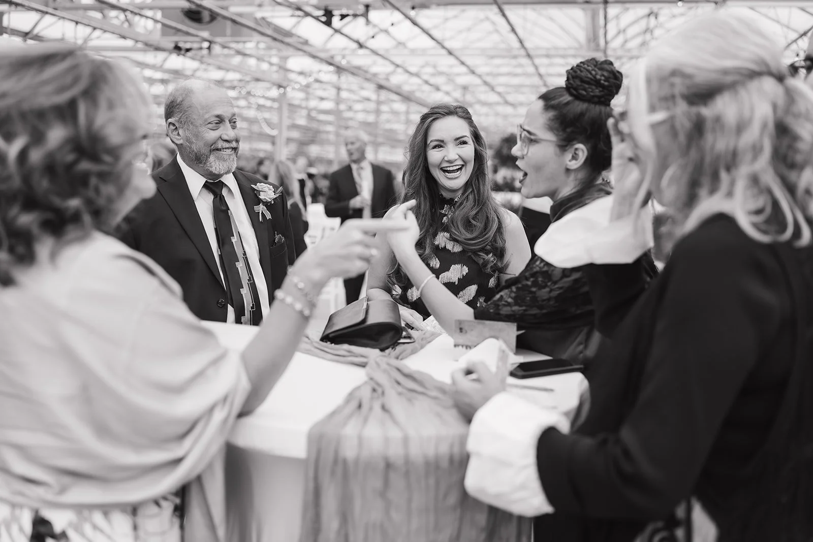 Black and white photo of guests mingling during cocktail hour.