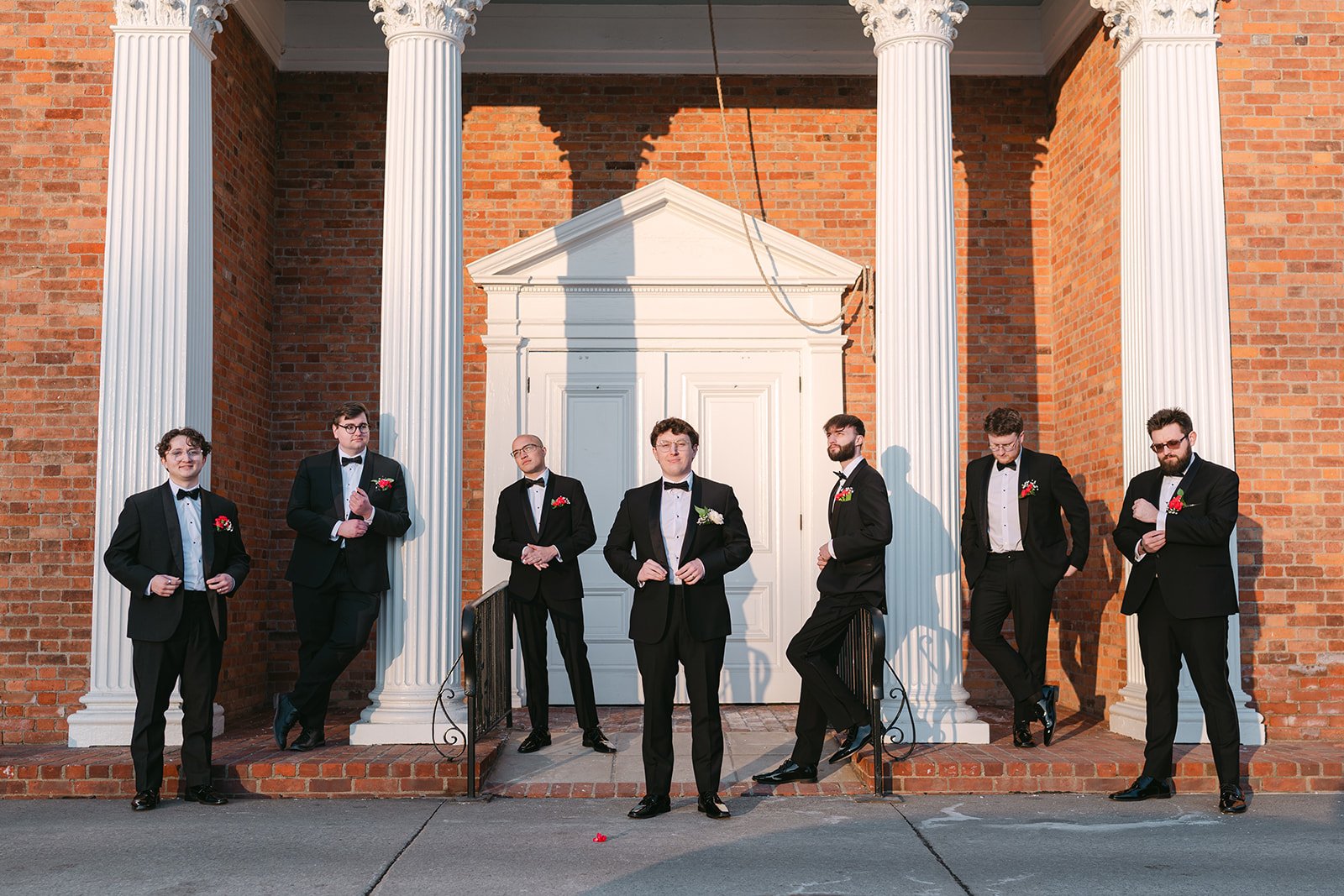 Outdoor groom and groomsmen photos outside of Martha-Mary Chapel at Greenfield Village.