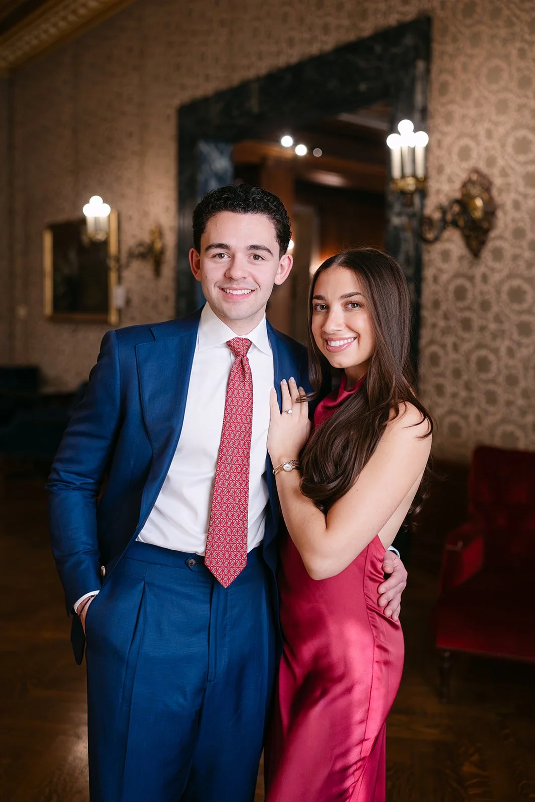 Couple smiling during their Detroit engagement photos at The Detroit Athletic Club.