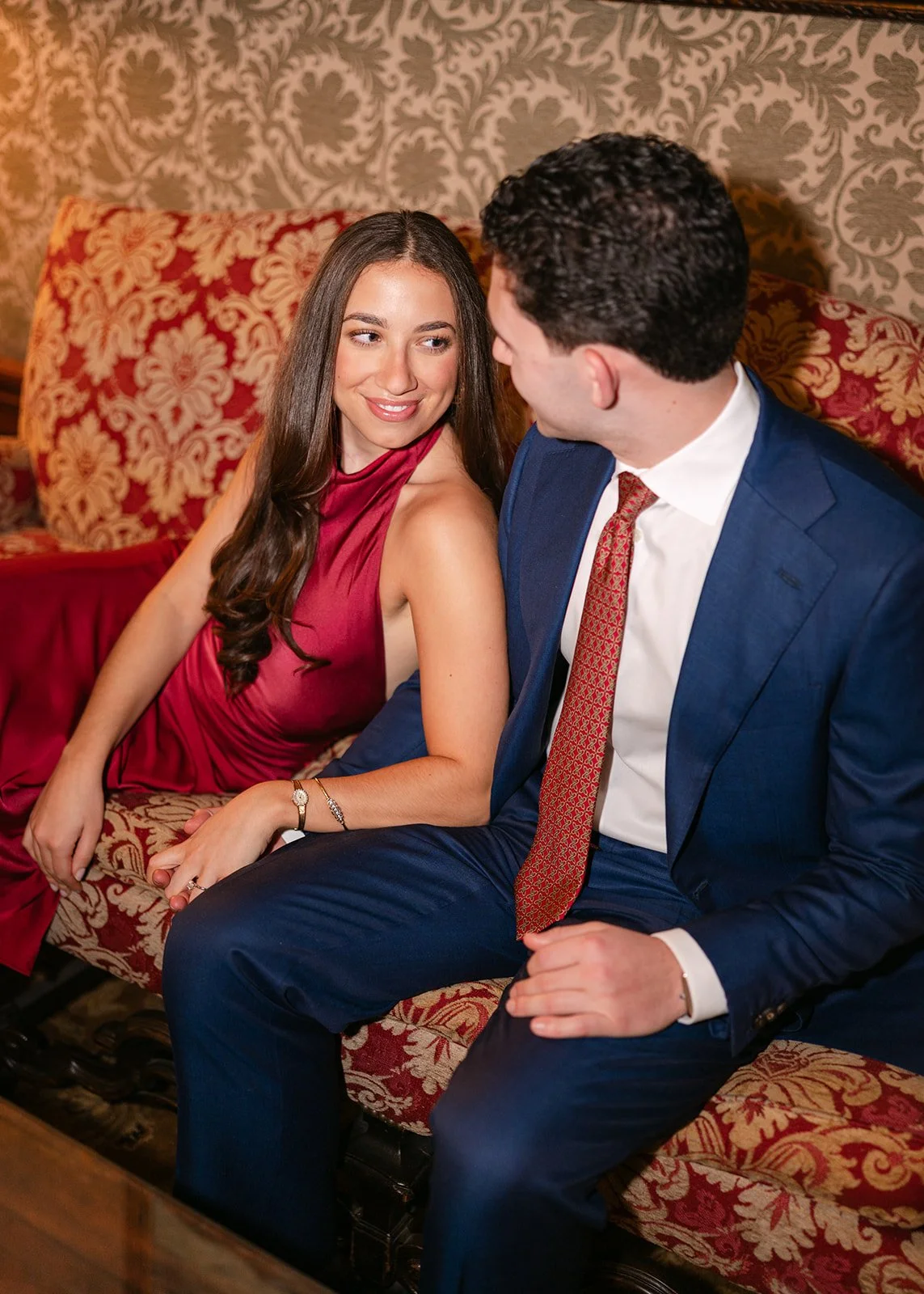 Couple posing on a couch together for their Detroit engagement photos at The DAC.