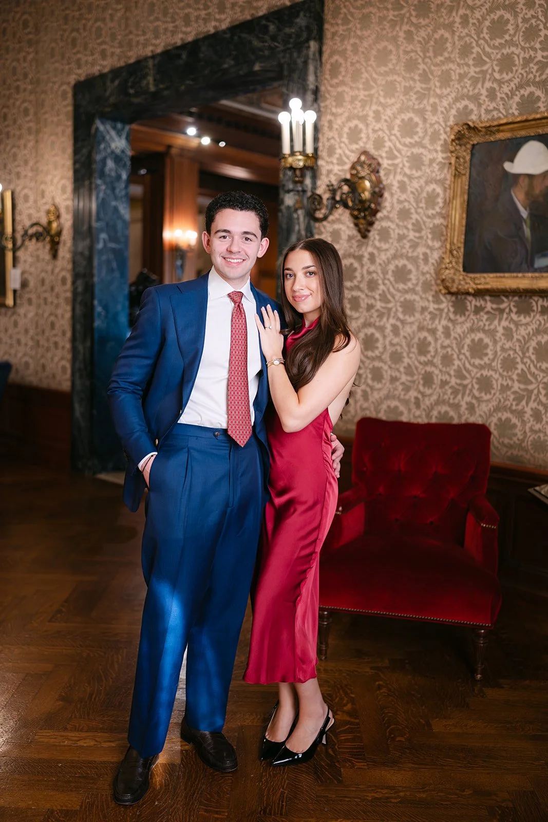 Couple posing inside of the Detroit Athletic Club for their engagement session.