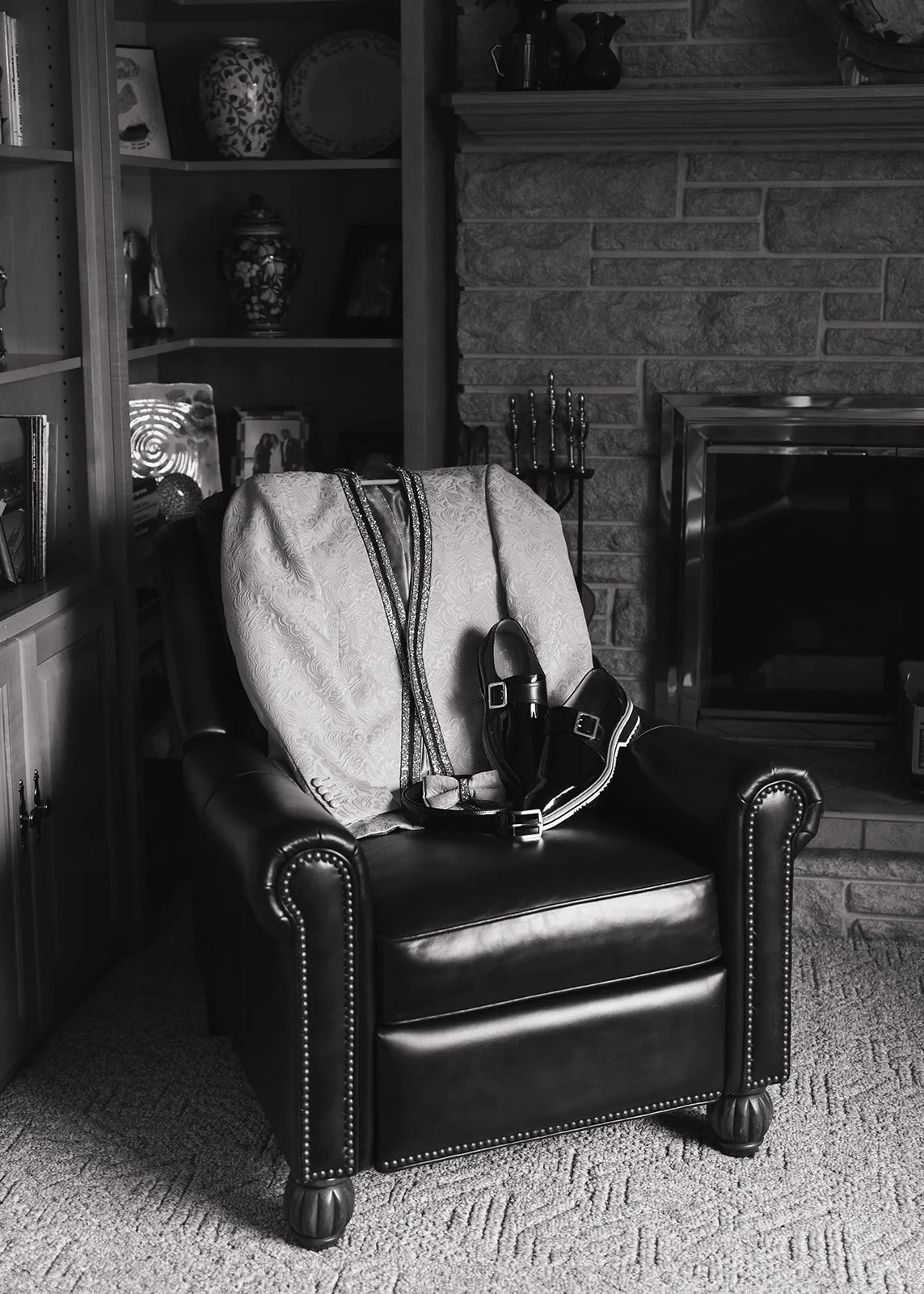 Black and white photo of the grooms suit and shoes st