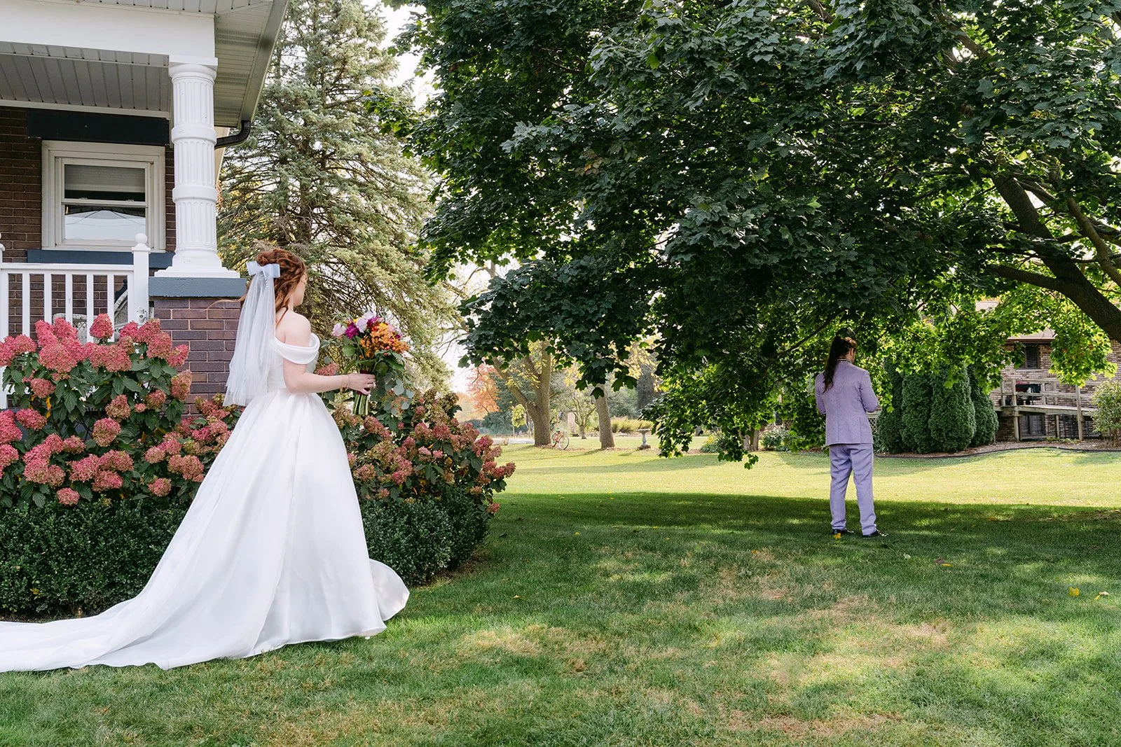 Bride approaching the groom outside of Brownstone Haus in Frankenmuth, Michigan for their first look.