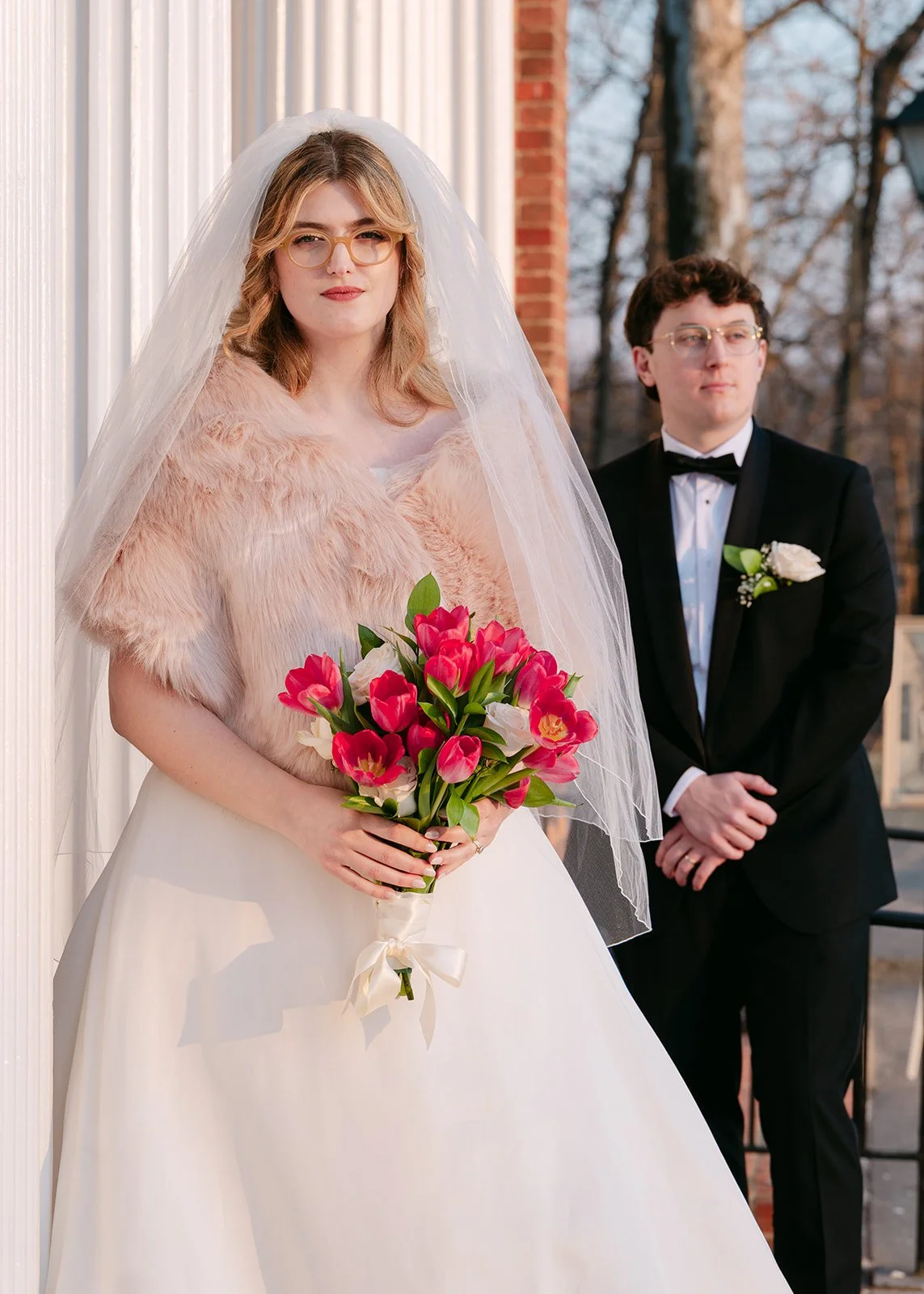 Bride and groom posing outside of Eagle Tavern for their Greenfield Village wedding portraits.