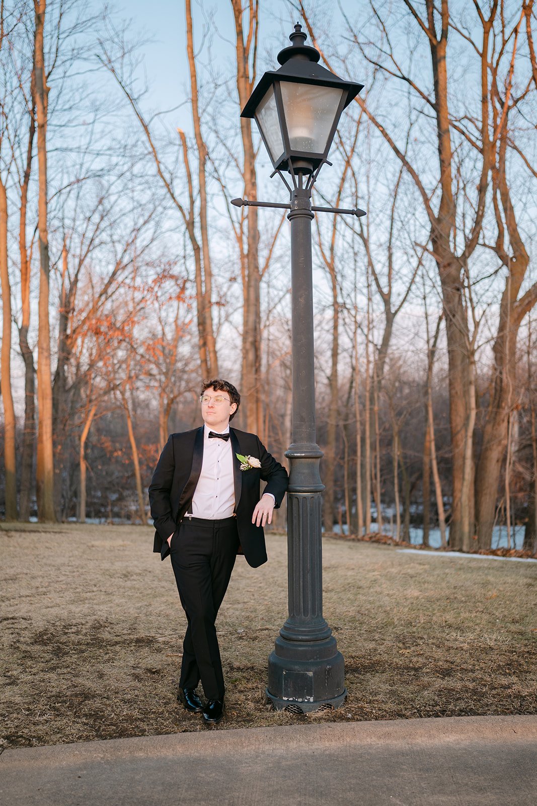 Groo leaning against a street light during his Greenfield Village wedding portraits.