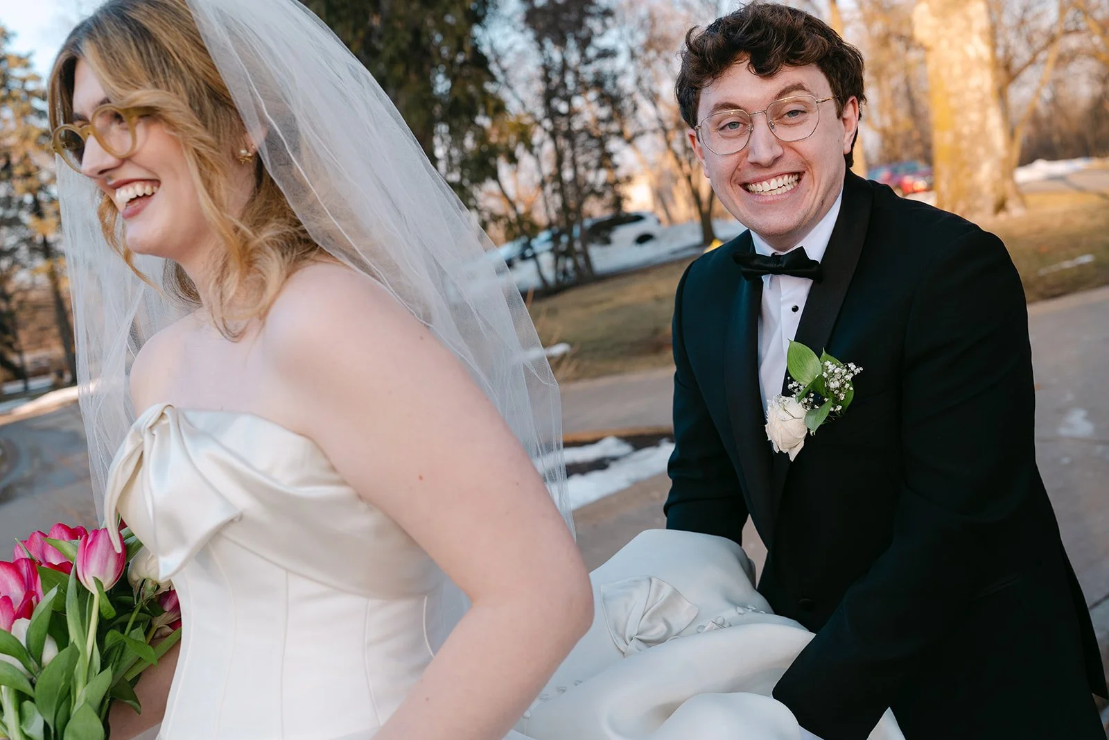 Candid photo of a bride and groom walking together after their ceremony.