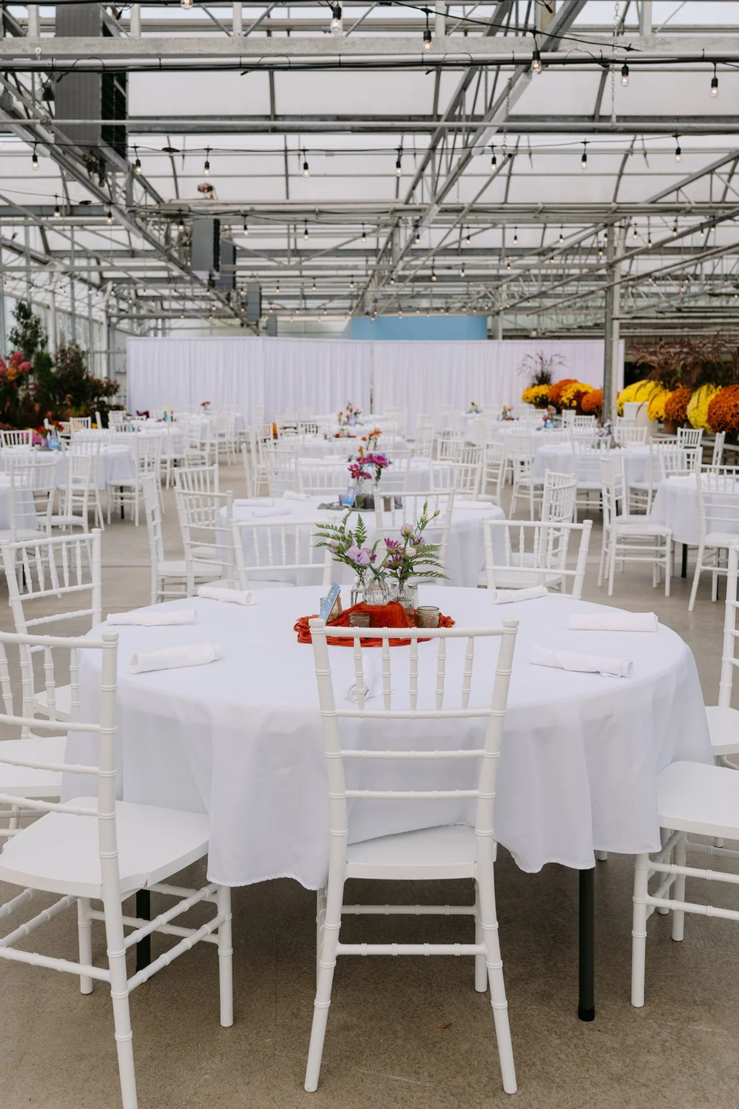 Reception tables setup inside Abele Greenhouse wedding venue in Saginaw, Michigan.