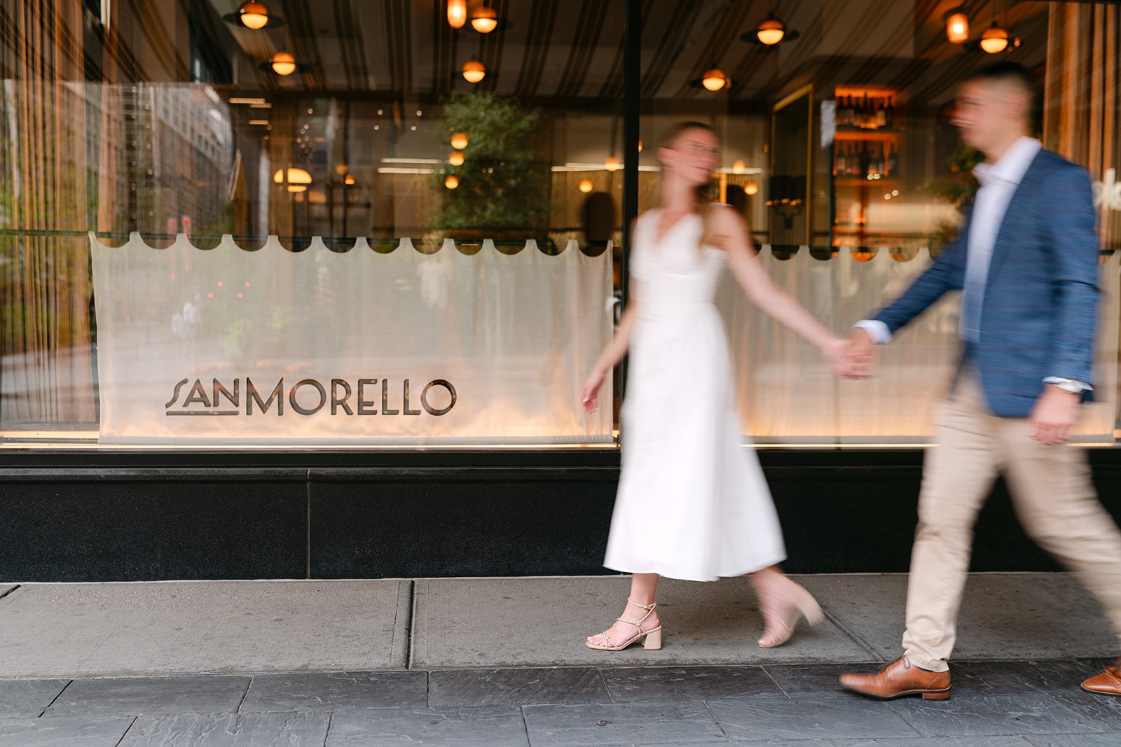 Couple walking downtown outside of San Morello in Detroit.