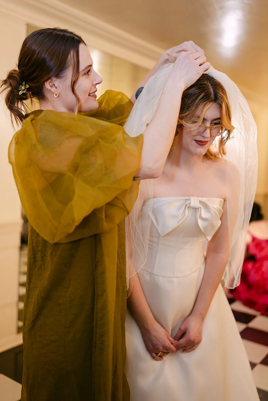 Bride getting her veil put on.