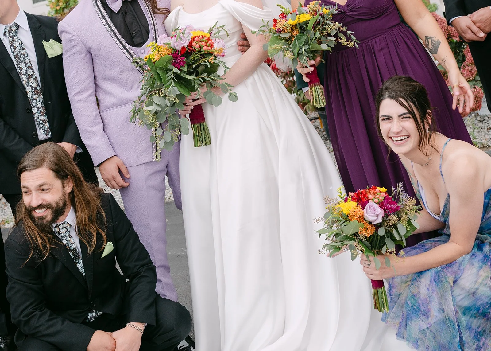 Close up photo of the wedding party surrounding the bride and groom during portraits.