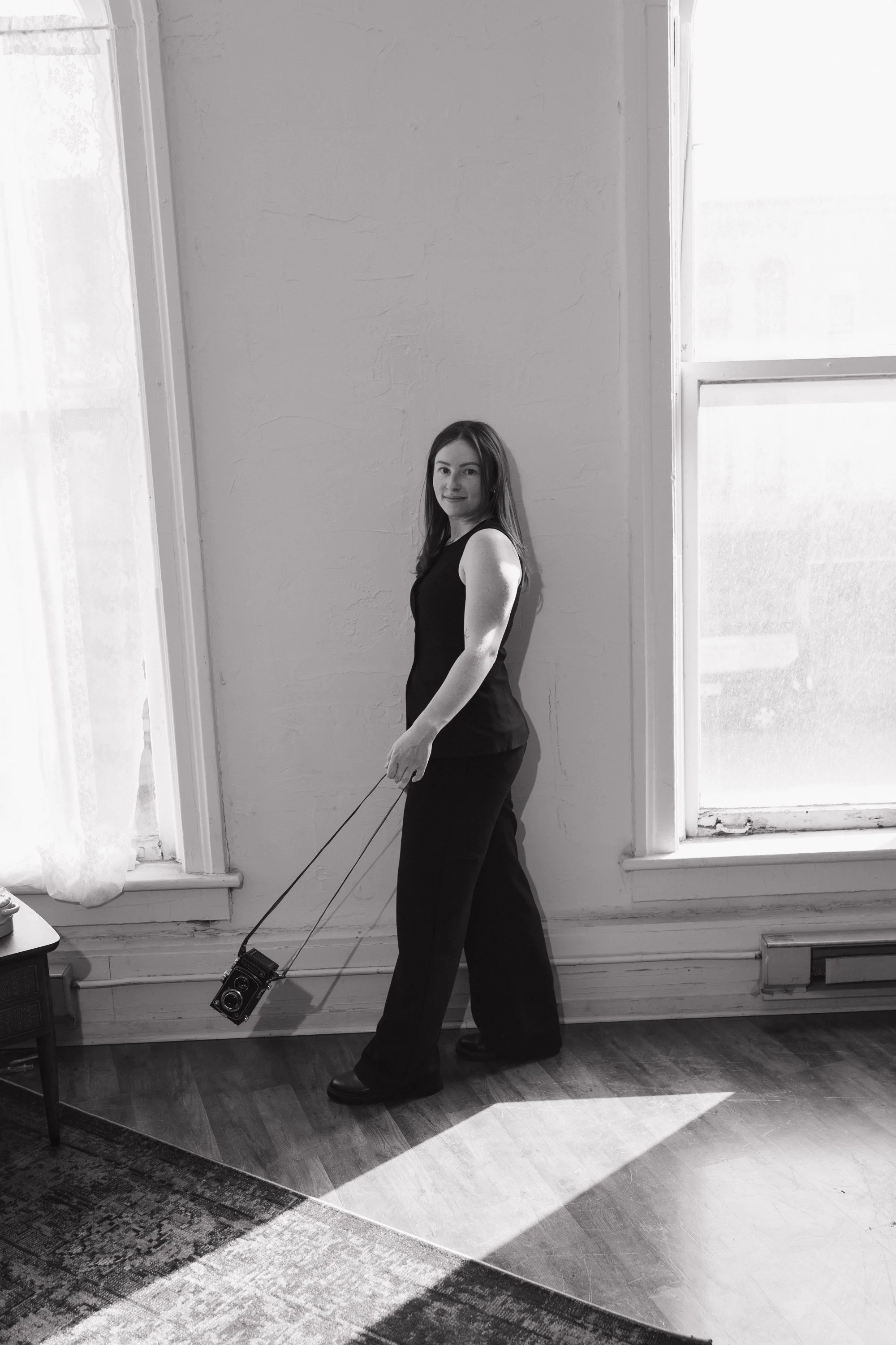 Black and white portrait of Alaina of Alaina Miller Photography posing for a brand photo.