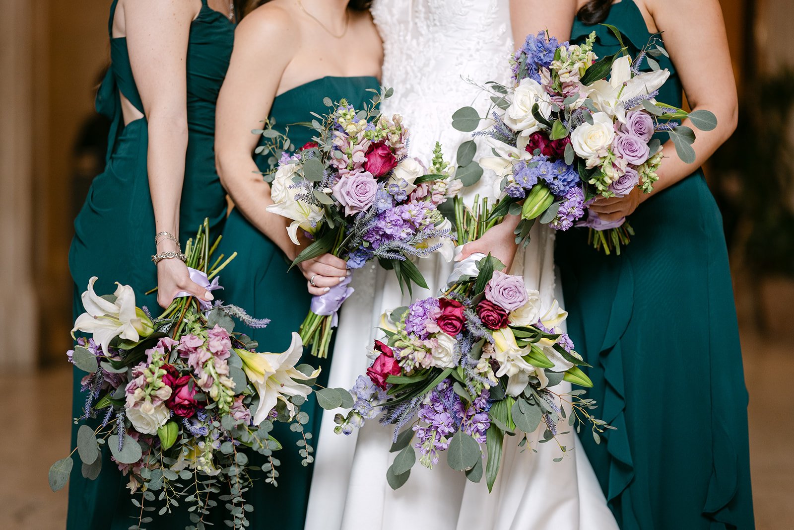 Close up shot of a bride and bridesmaids holding bouquets inside Book Tower in Detroit.