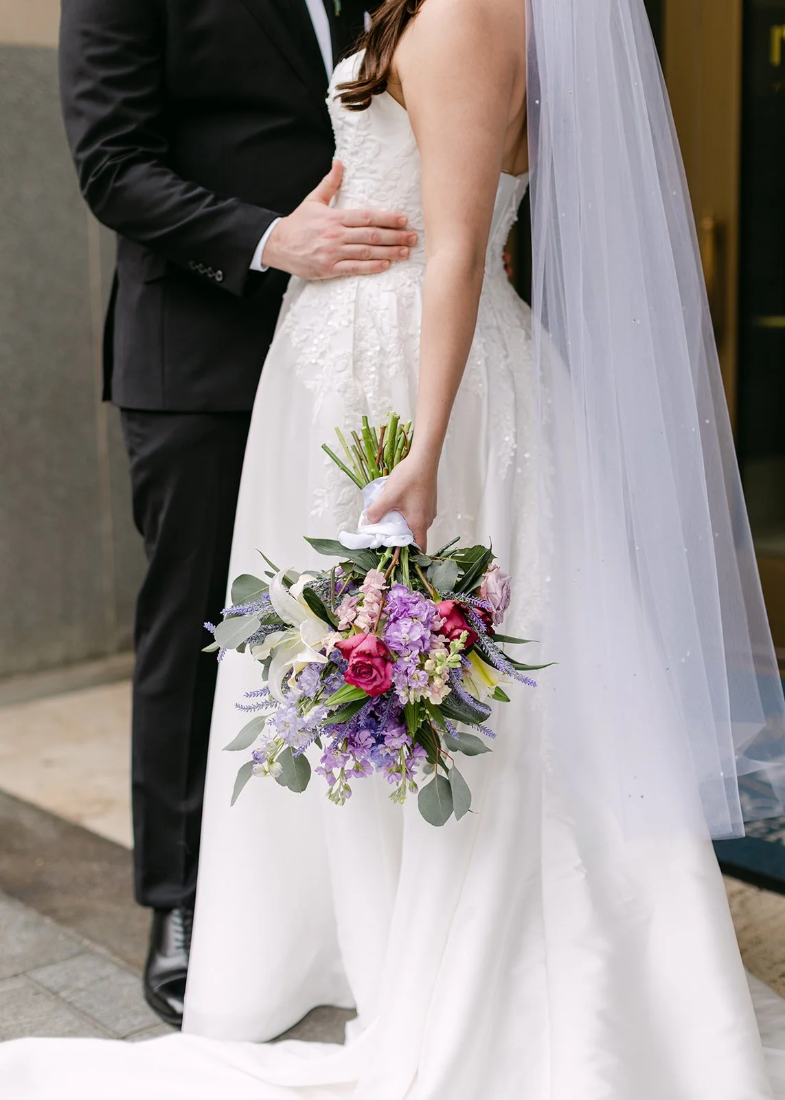 Close up photo of a bride and groom posing together in downtown Detroit.
