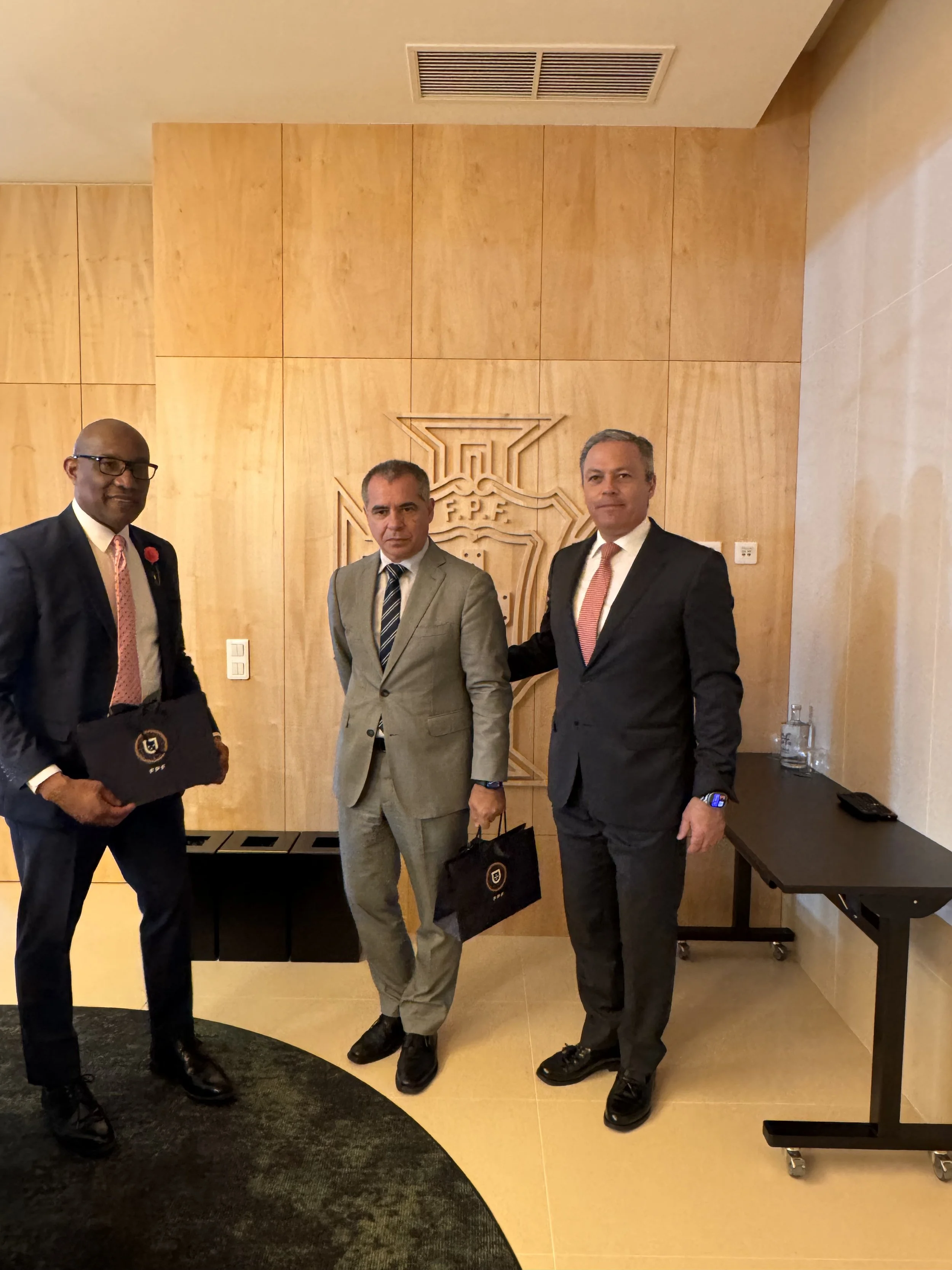 Dr. Philbert Aaron in a bilateral meeting with the Portuguese Football Federation on the sidelines of official diplomatic business — Lisbon, Portugal, May 2026.
