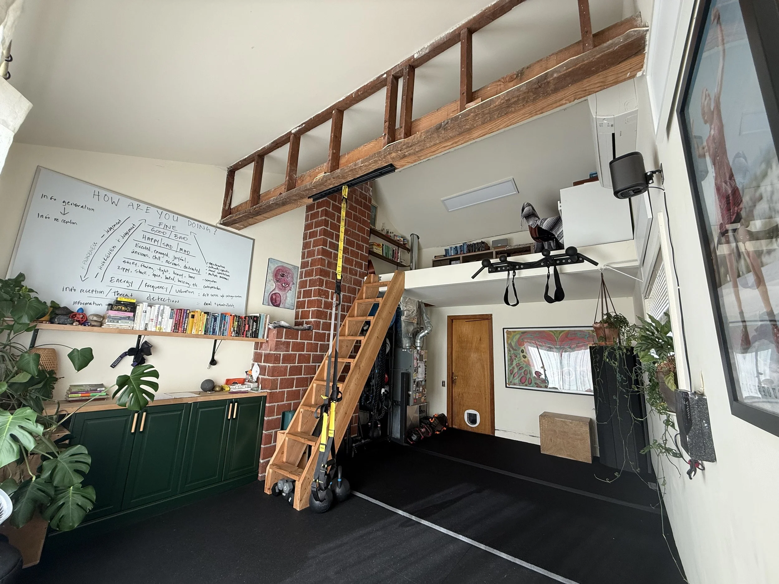 A private fitness studio in portland, Oregon. An open space, with cream color walls, green houseplants, and an inviting atmosphere.