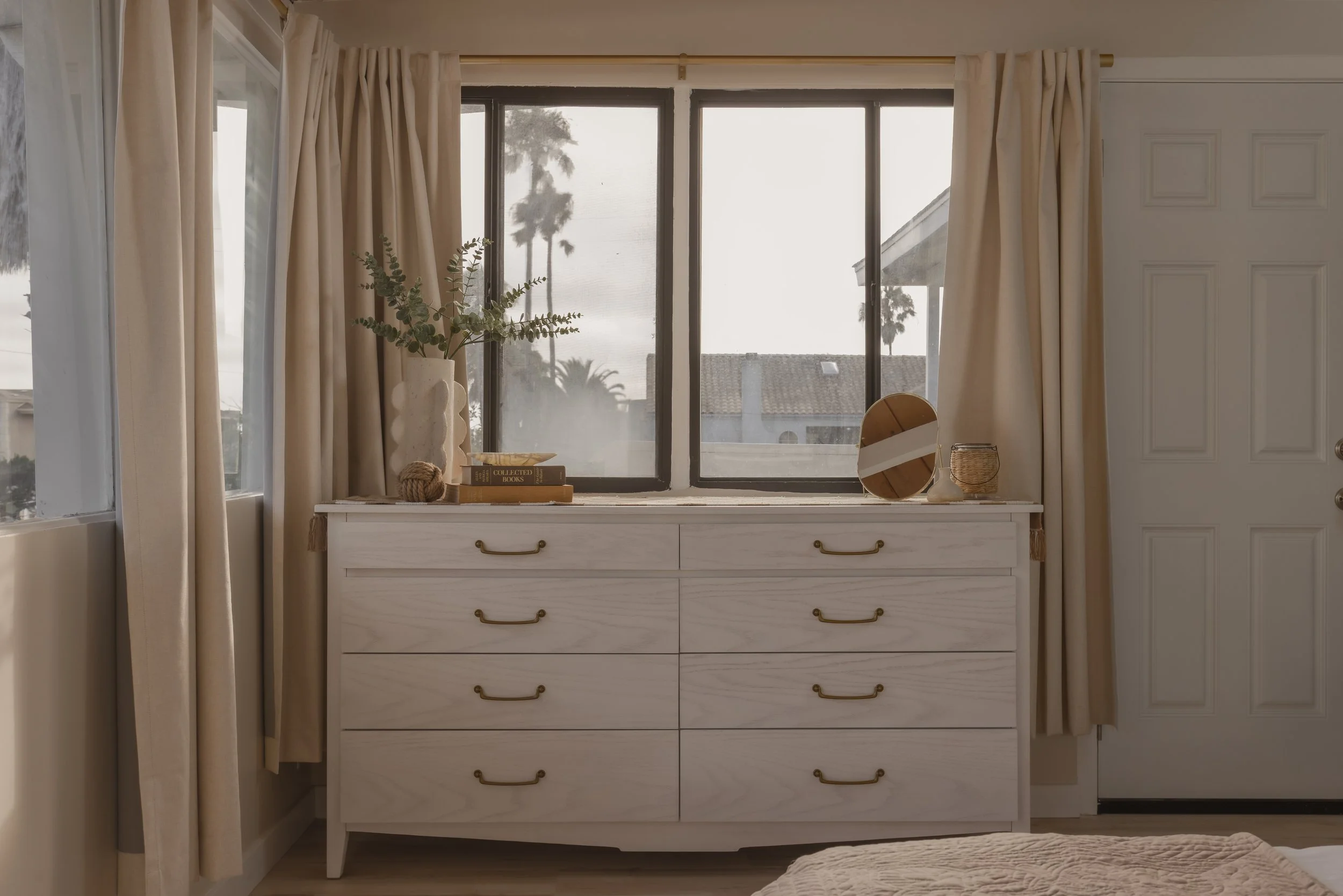 Coastal seashell bedroom with thrifted furniture, books, and decor