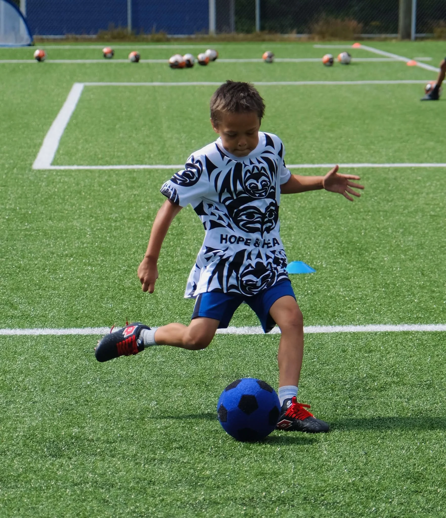 H&H Boy Kicking ball.jpg
