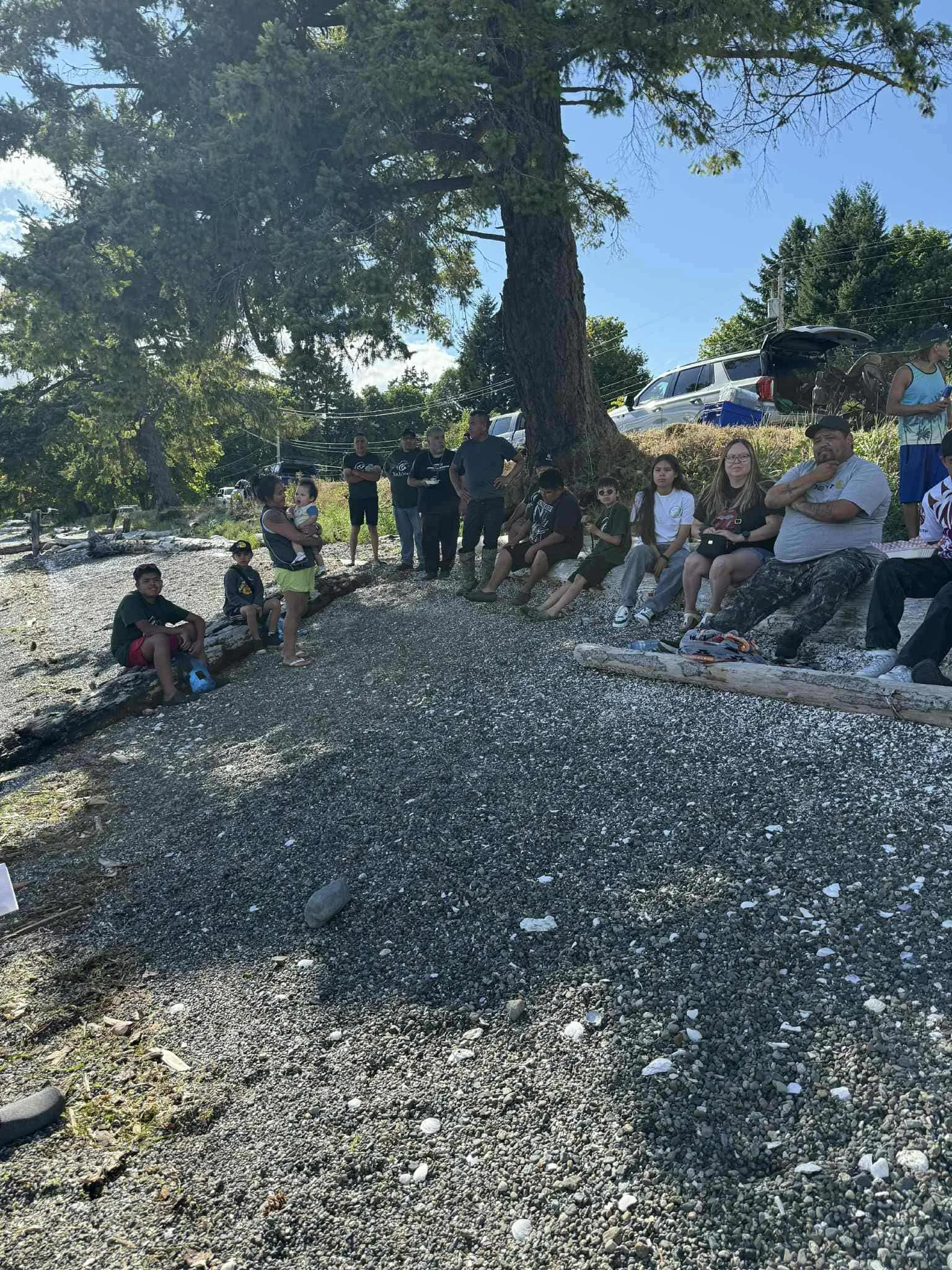 Community members catching shade at Fishing Debry on shore.jpg