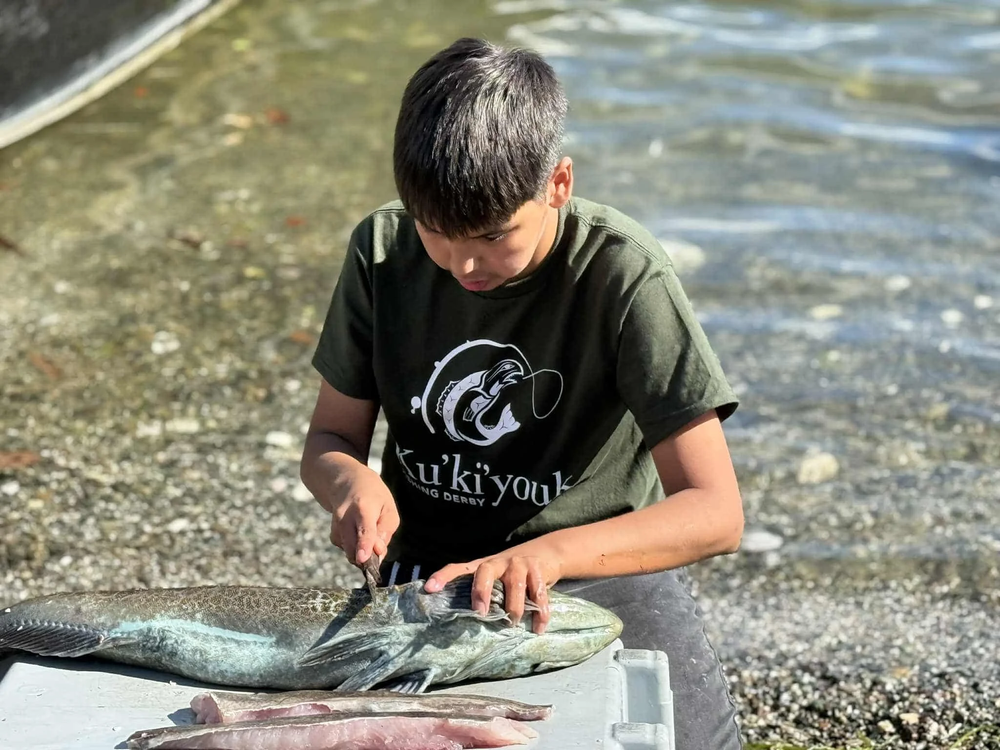 Youth preparing his catch.jpg
