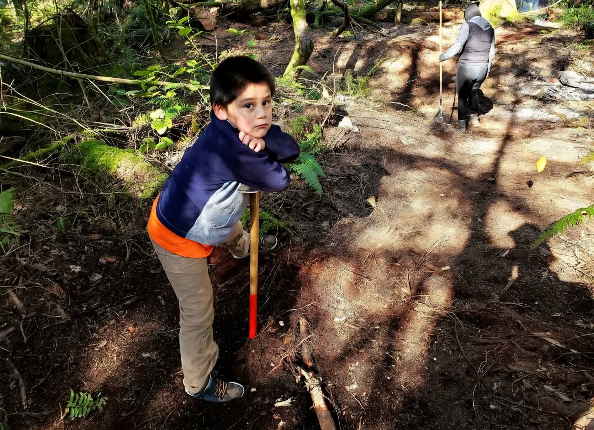 Penelakut kiddo helping build trail.jpg