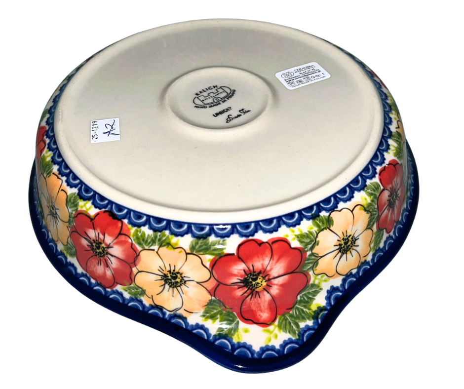 Kalich Polish Pottery floral pattern with red and yellow blossoms, white accents, and green foliage on cream with cobalt rim; hand-painted meadow design with light, airy composition.