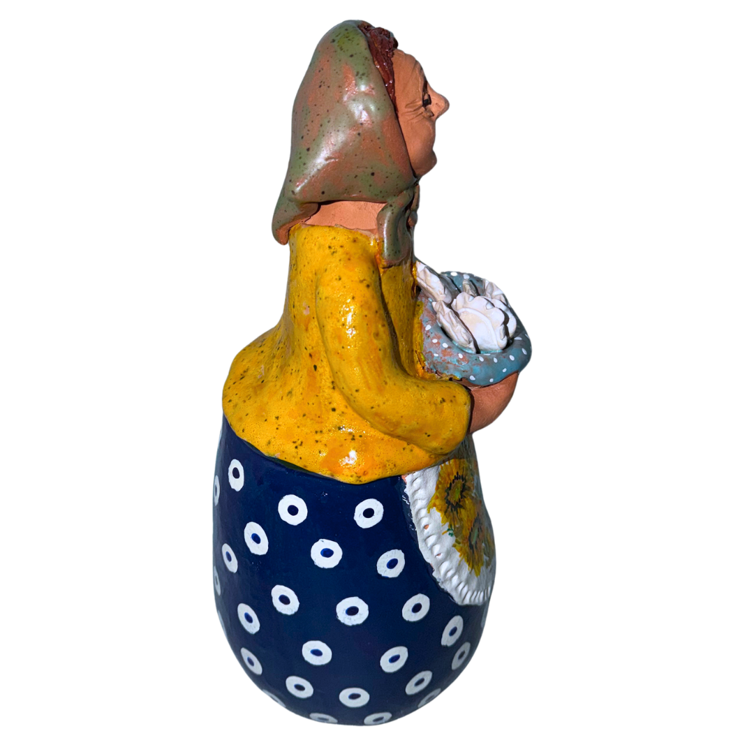 Hand-painted handcrafted babcia figurine holding a bowl of pierogi.