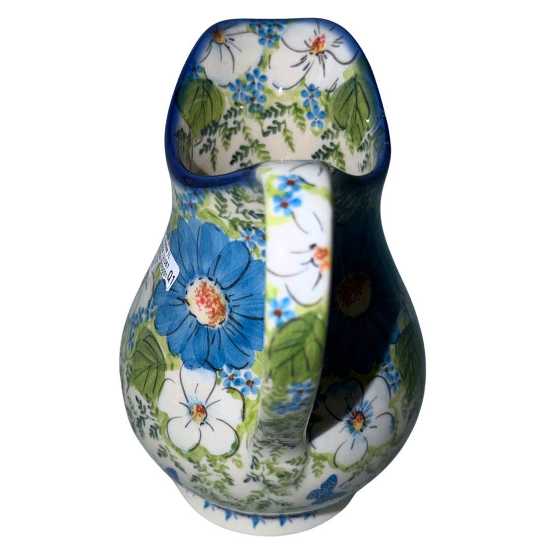 Ceramika Kalich Polish Pottery 37 oz Kubus pitcher with blue and white flowers, green foliage and butterflies, handcrafted in Bolesławiec, Poland.