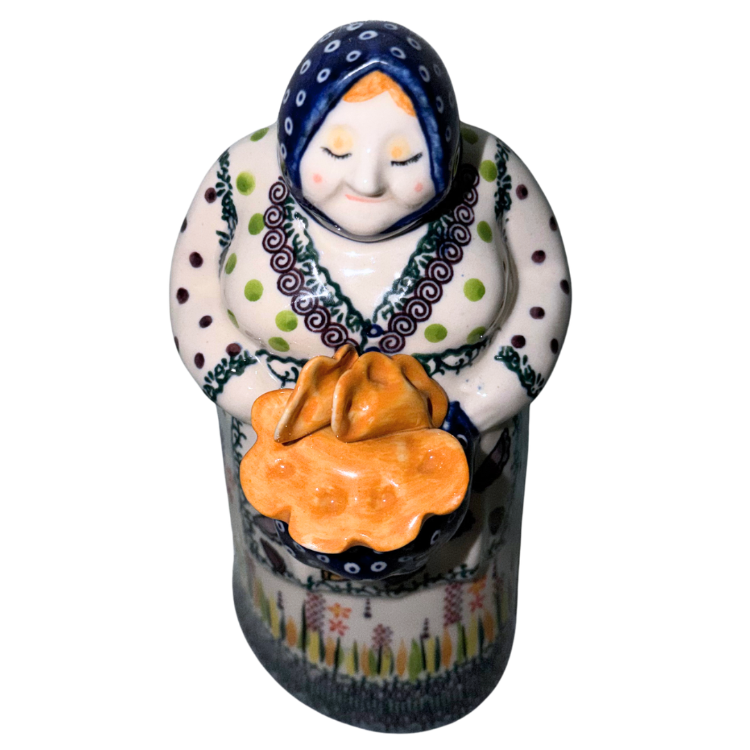 Galia Polish Pottery Babcia holding a bowl of pierogi. 9-inch handmade and hand-painted Polish Grannie figurine from the Bolesławiec region of Poland.