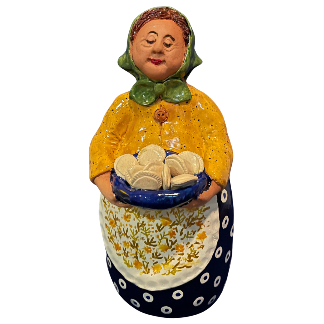 Hand-painted handcrafted babcia figurine holding a bowl of pierogi.