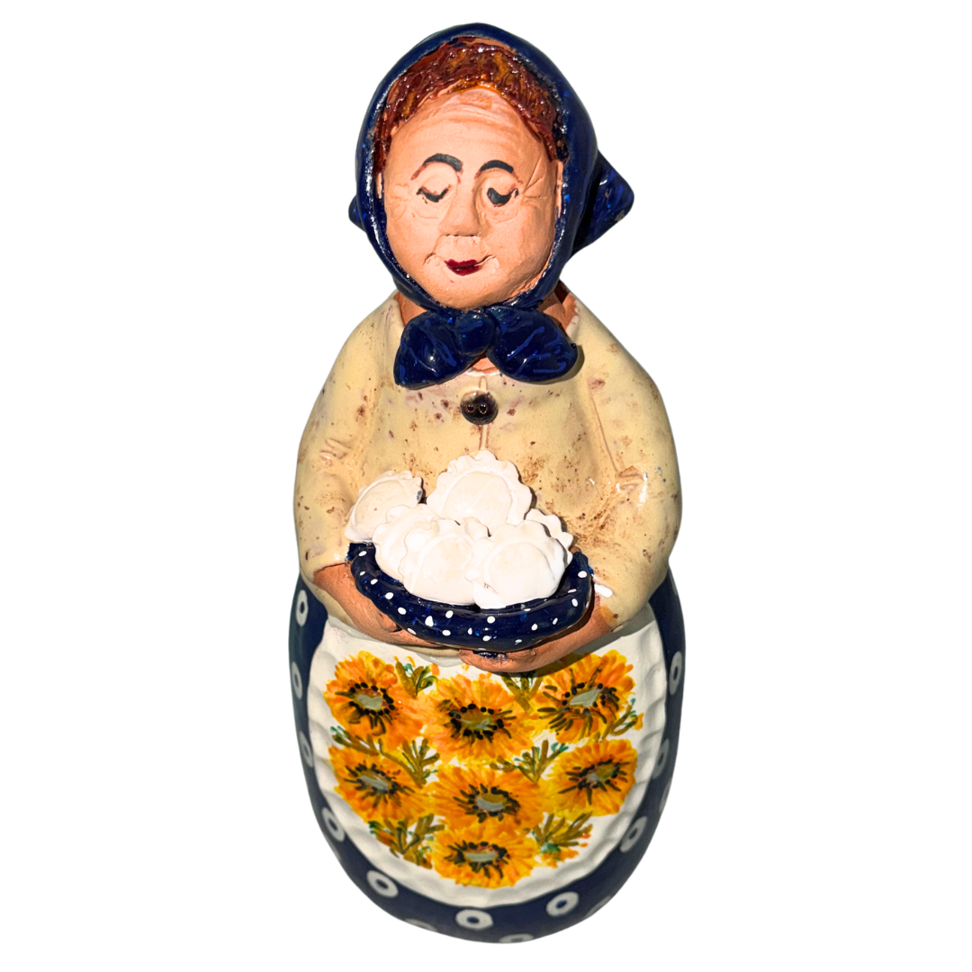 Hand-painted handcrafted babcia figurine holding a bowl of pierogi.