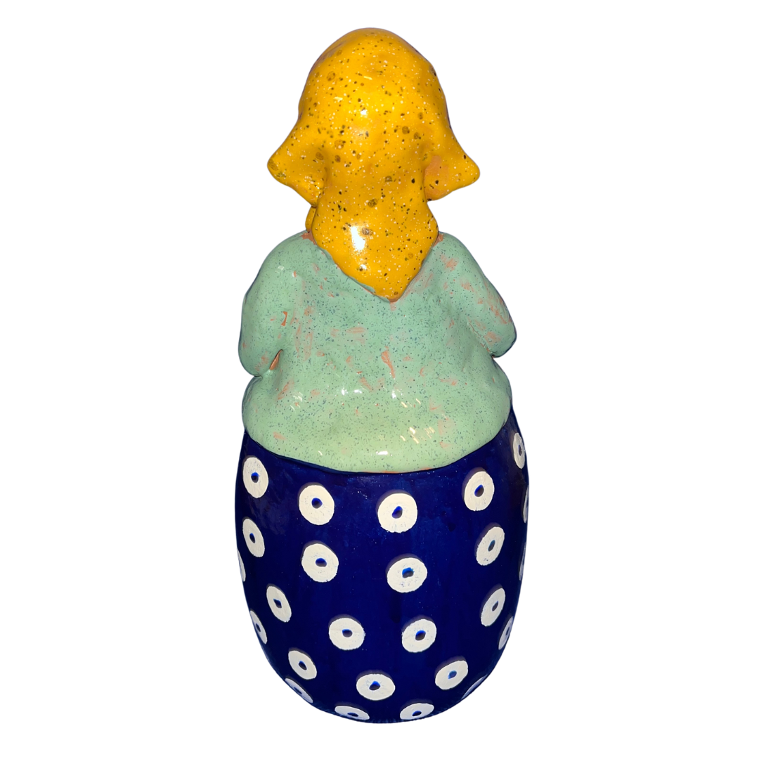 Charming hand-painted “Babcia Holding a Book” figurine featuring a Polish grandmother in an aqua scarf and floral apron. A heartwarming gift and beautiful piece of folk-inspired home décor.